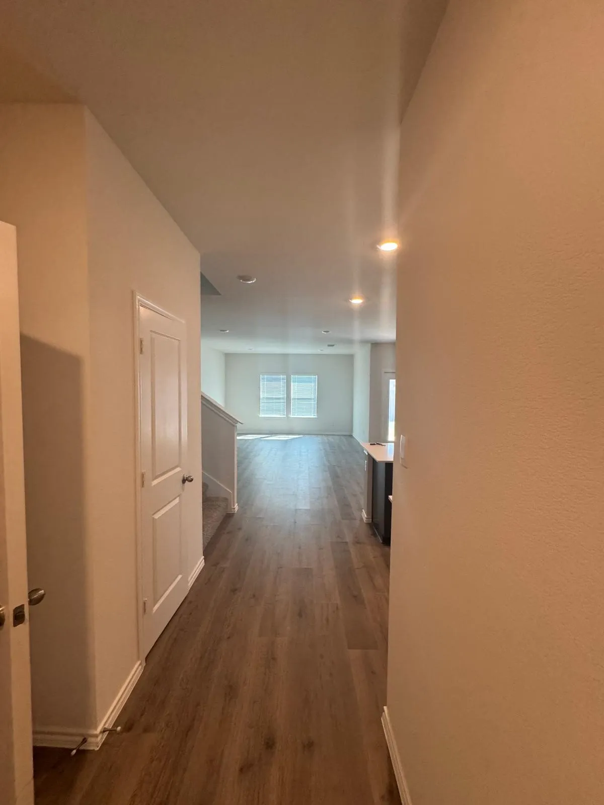 Hall featuring dark wood-style flooring and recessed lighting