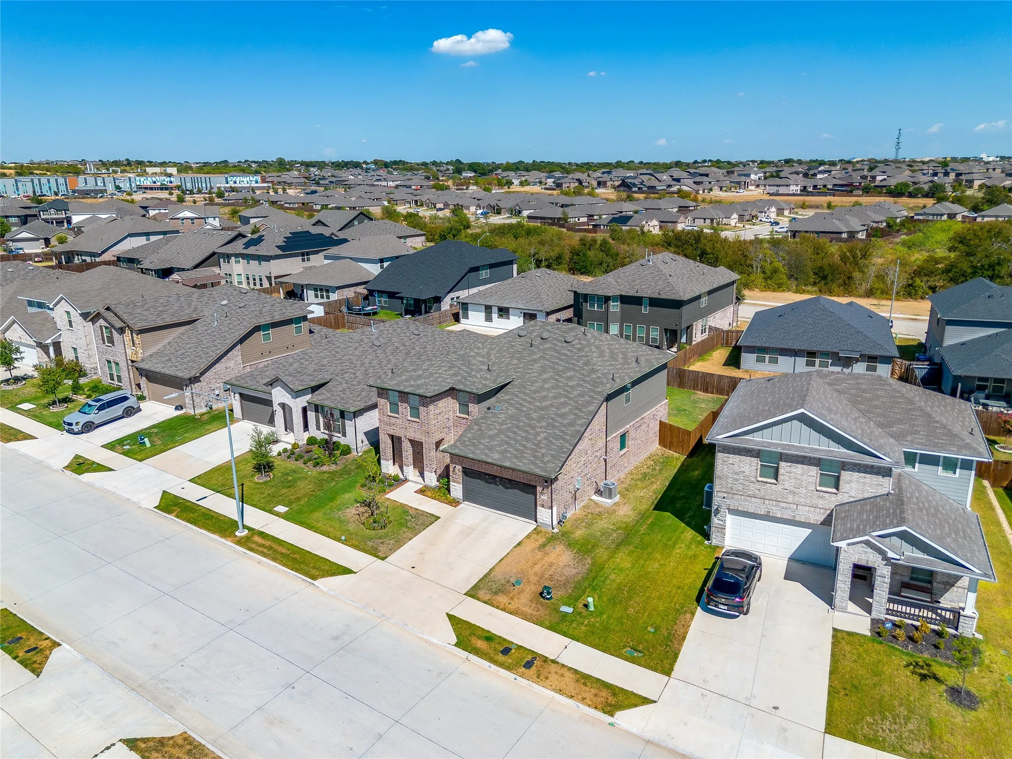 Expansive residential community featuring a variety of architectural styles, mature landscaping, and concrete driveways