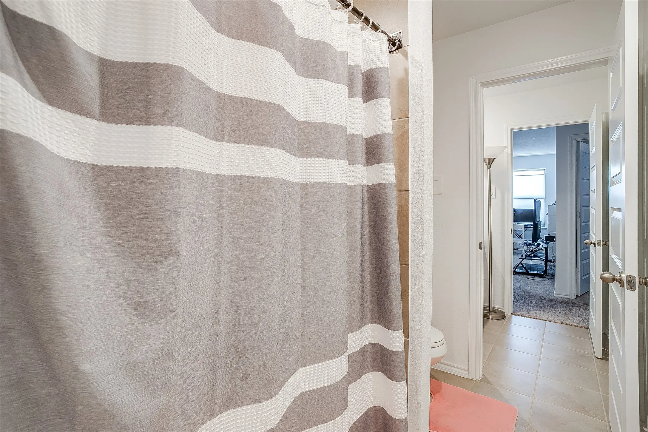 Tile flooring, panel doors, and a tiled shower enclosure