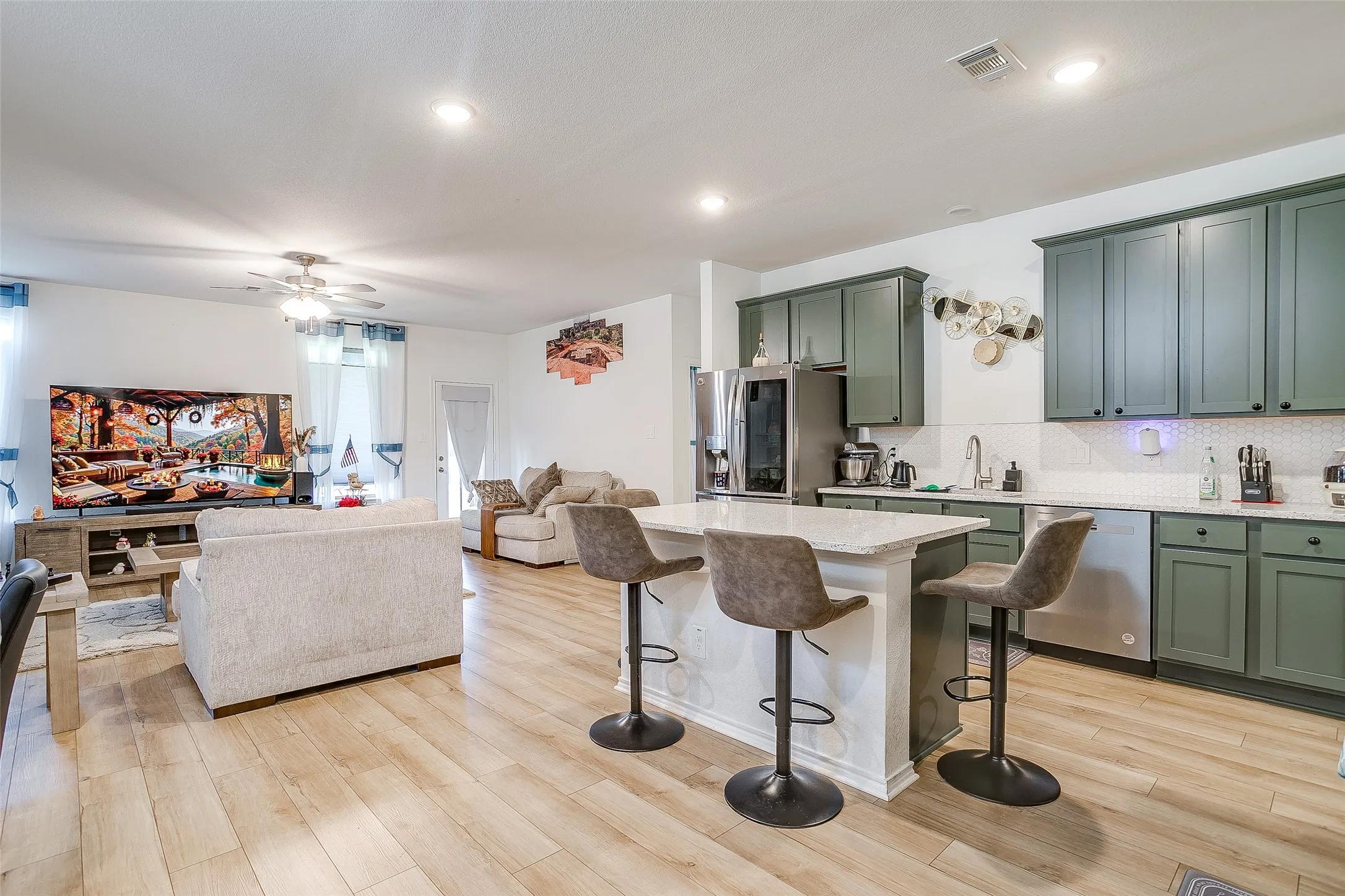 Open concept living space featuring wood-finish flooring, recessed lighting, and a ceiling fan