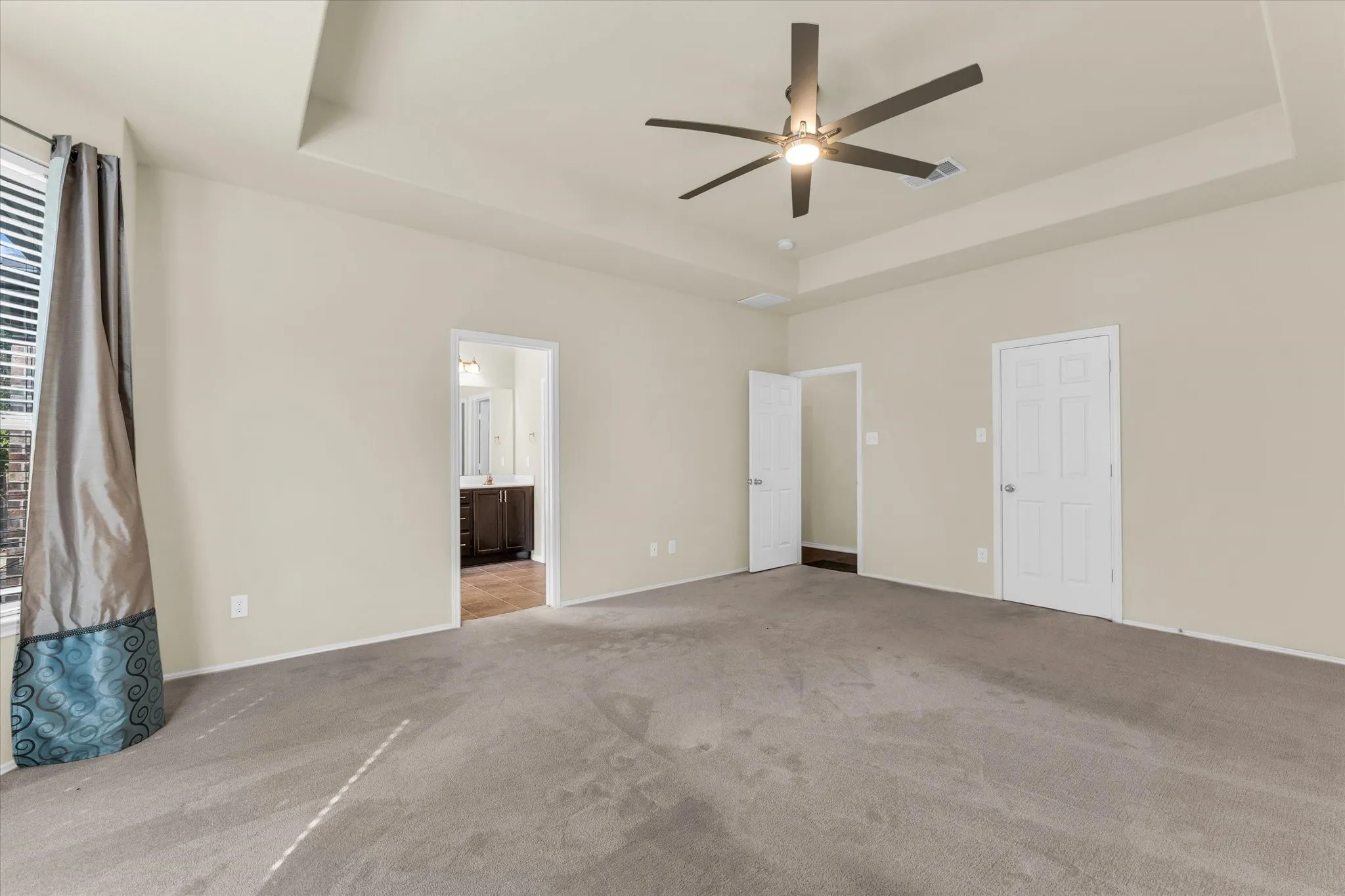 Recessed tray ceiling with a modern ceiling fan and integrated lighting