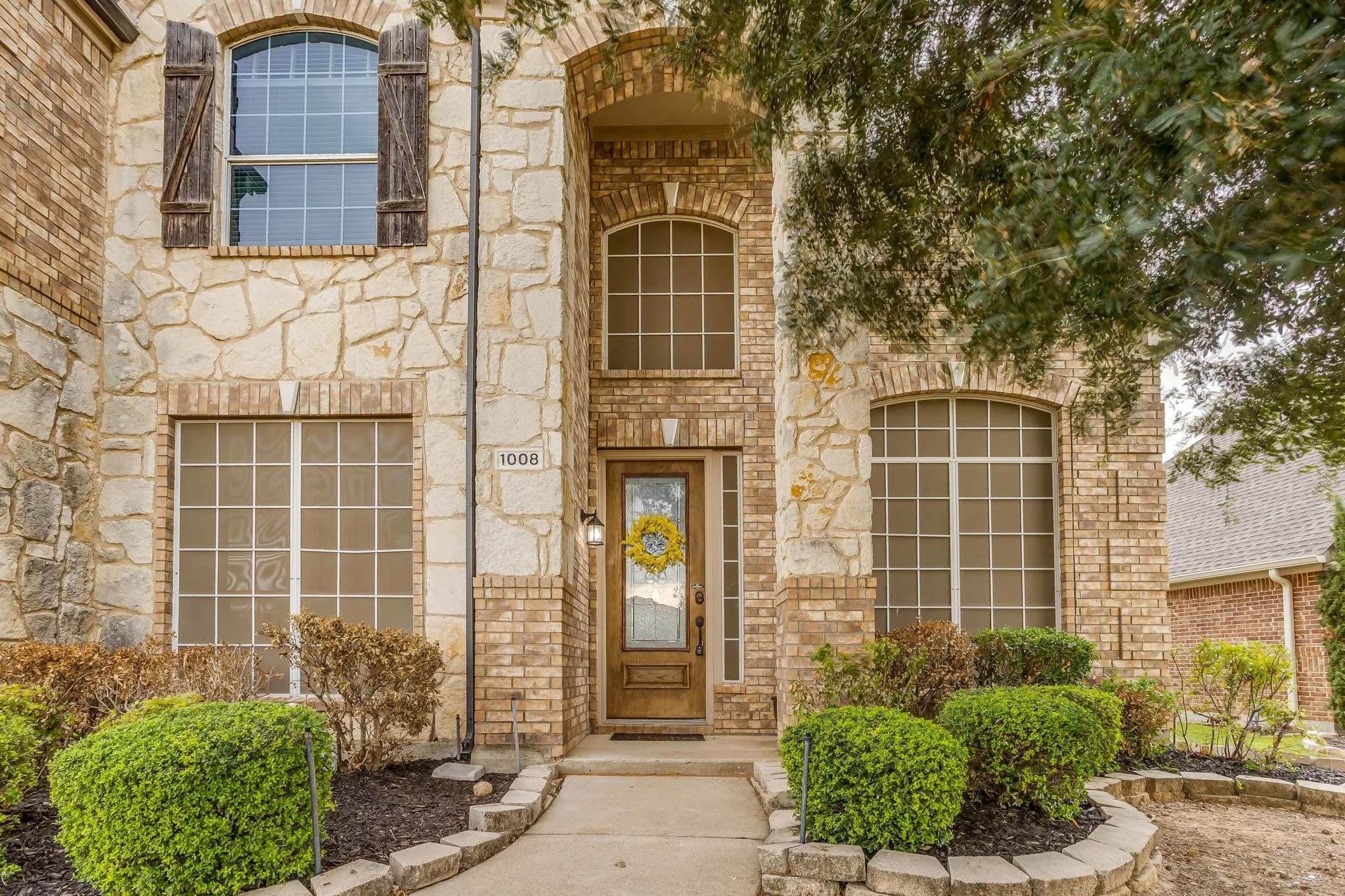 Stone and brick facade with arched windows and entryway