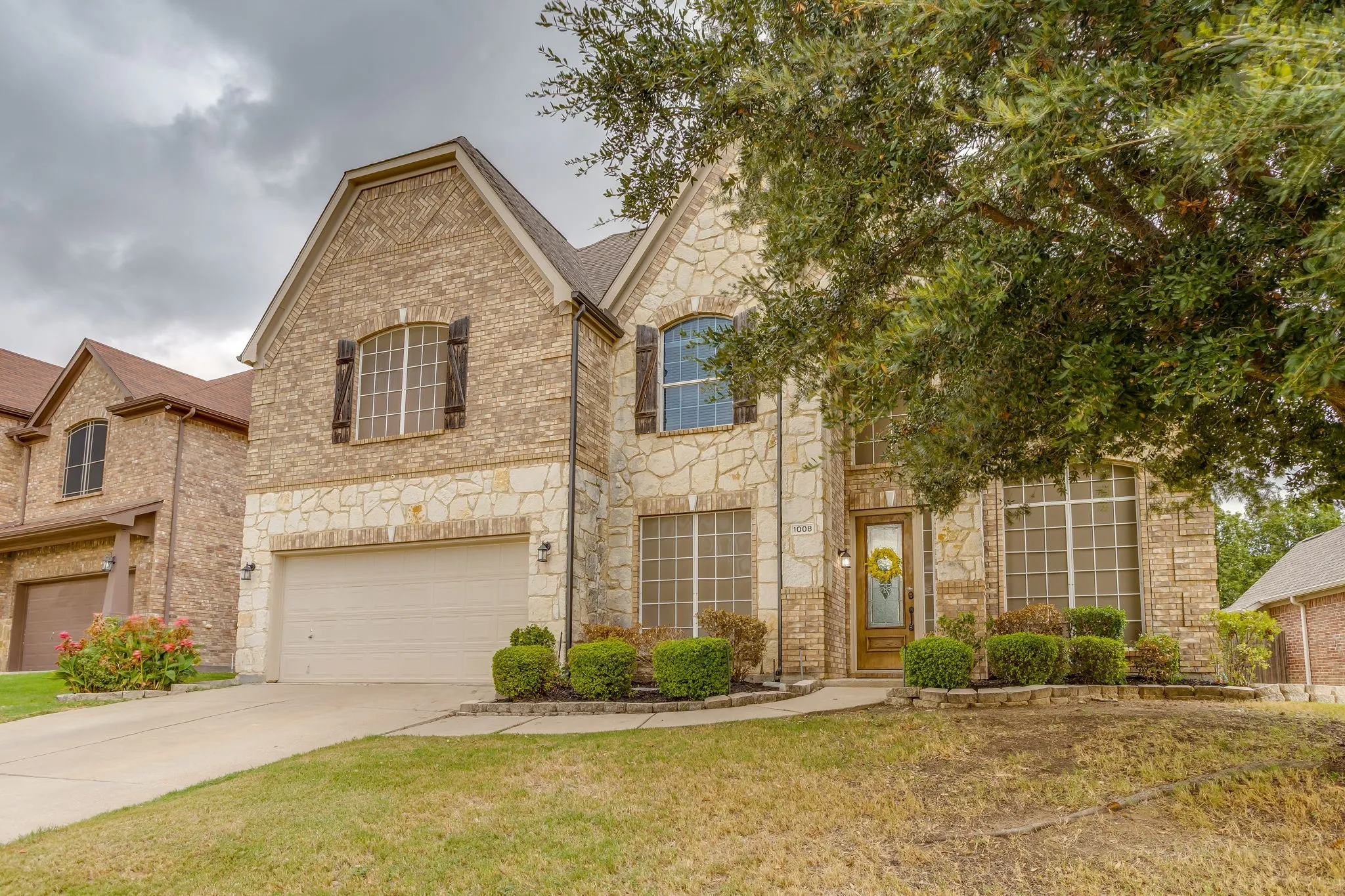 Brick and stone exterior with arched windows and dark shutters