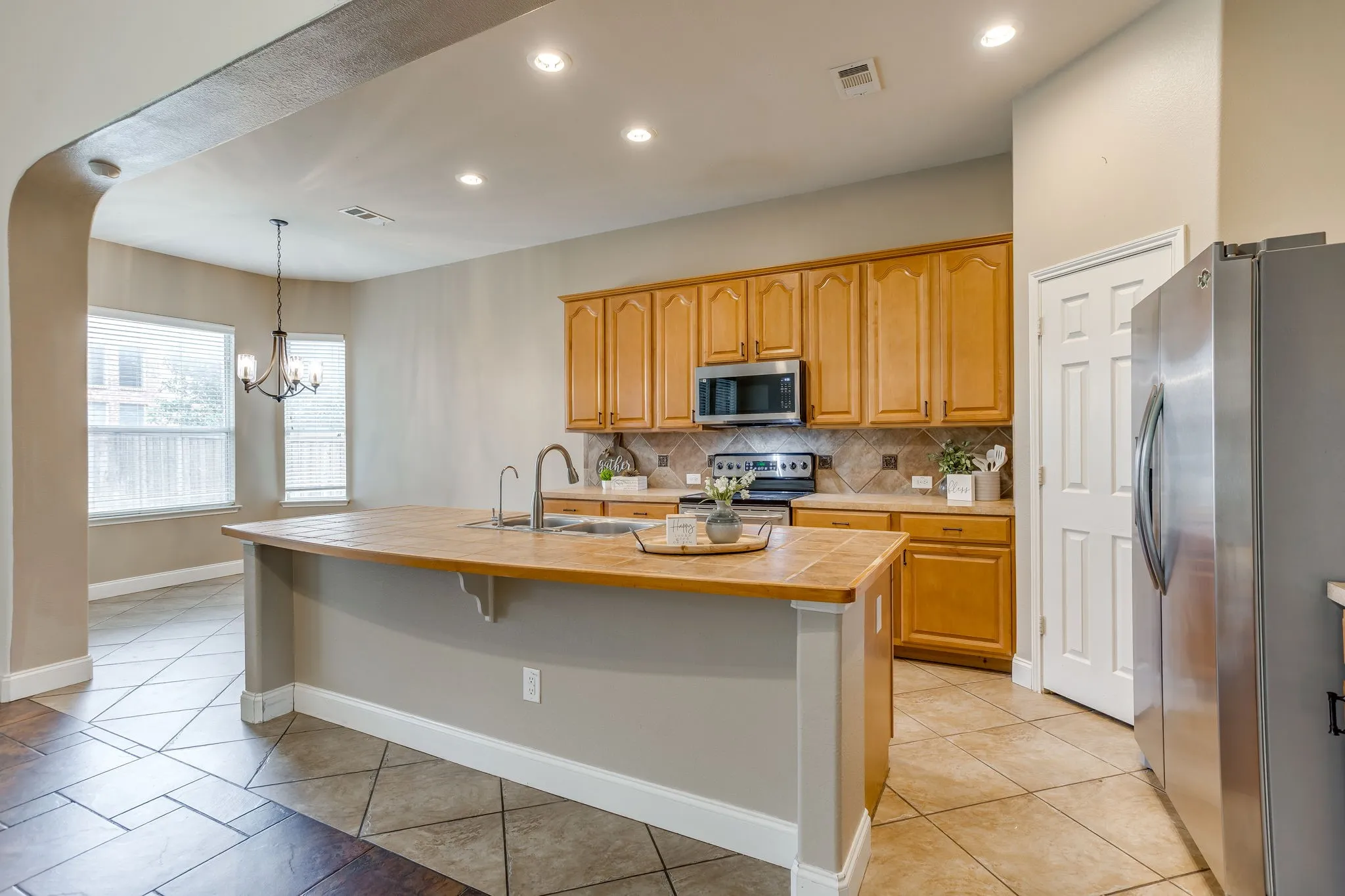 Kitchen island with a built-in sink and elevated countertop