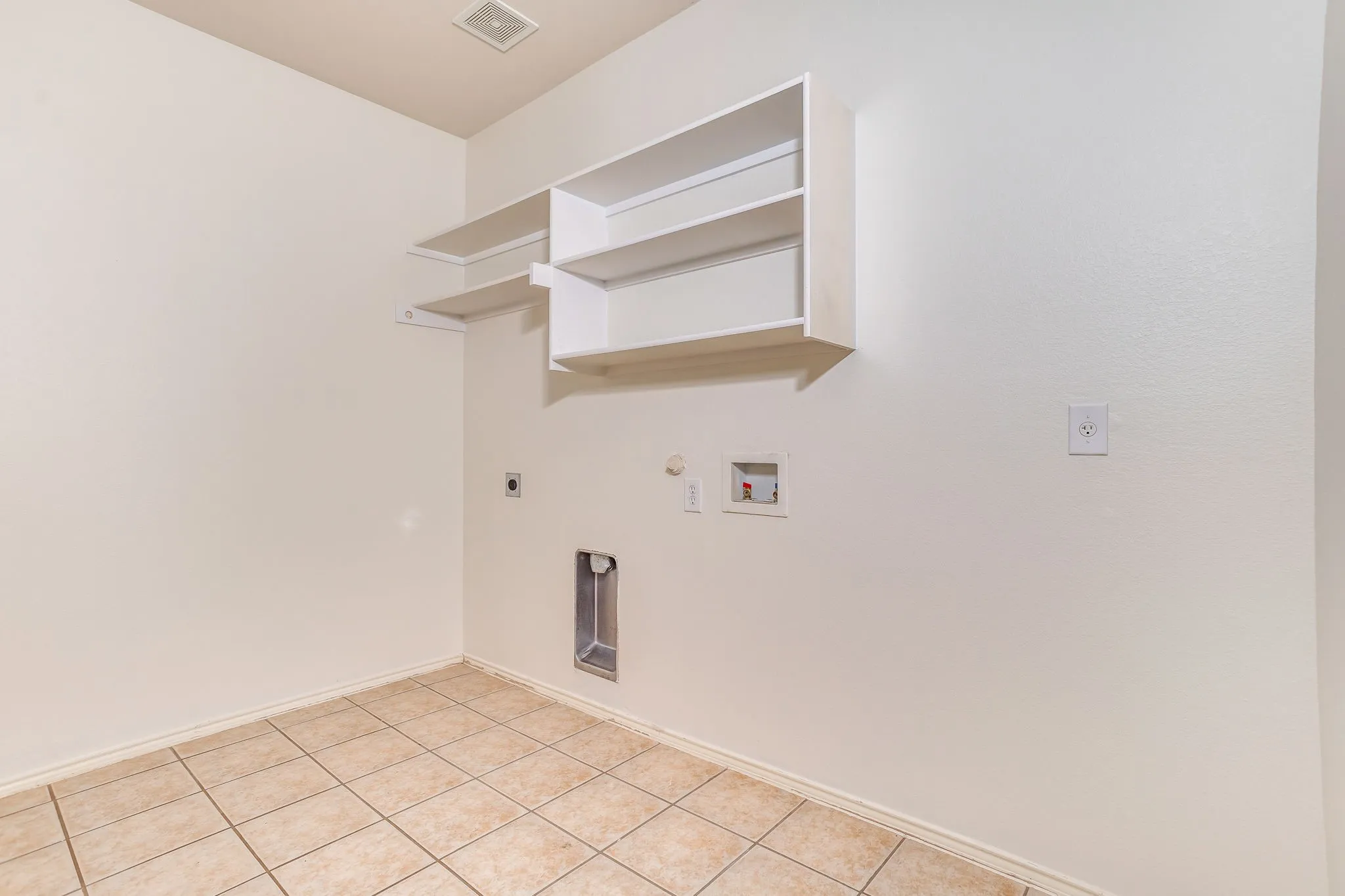 Tile flooring, built-in shelving, and utility hookups