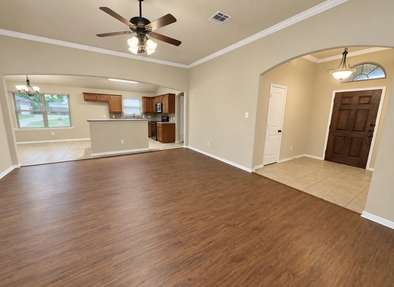 Wood-finish flooring, recessed lighting, and crown molding
