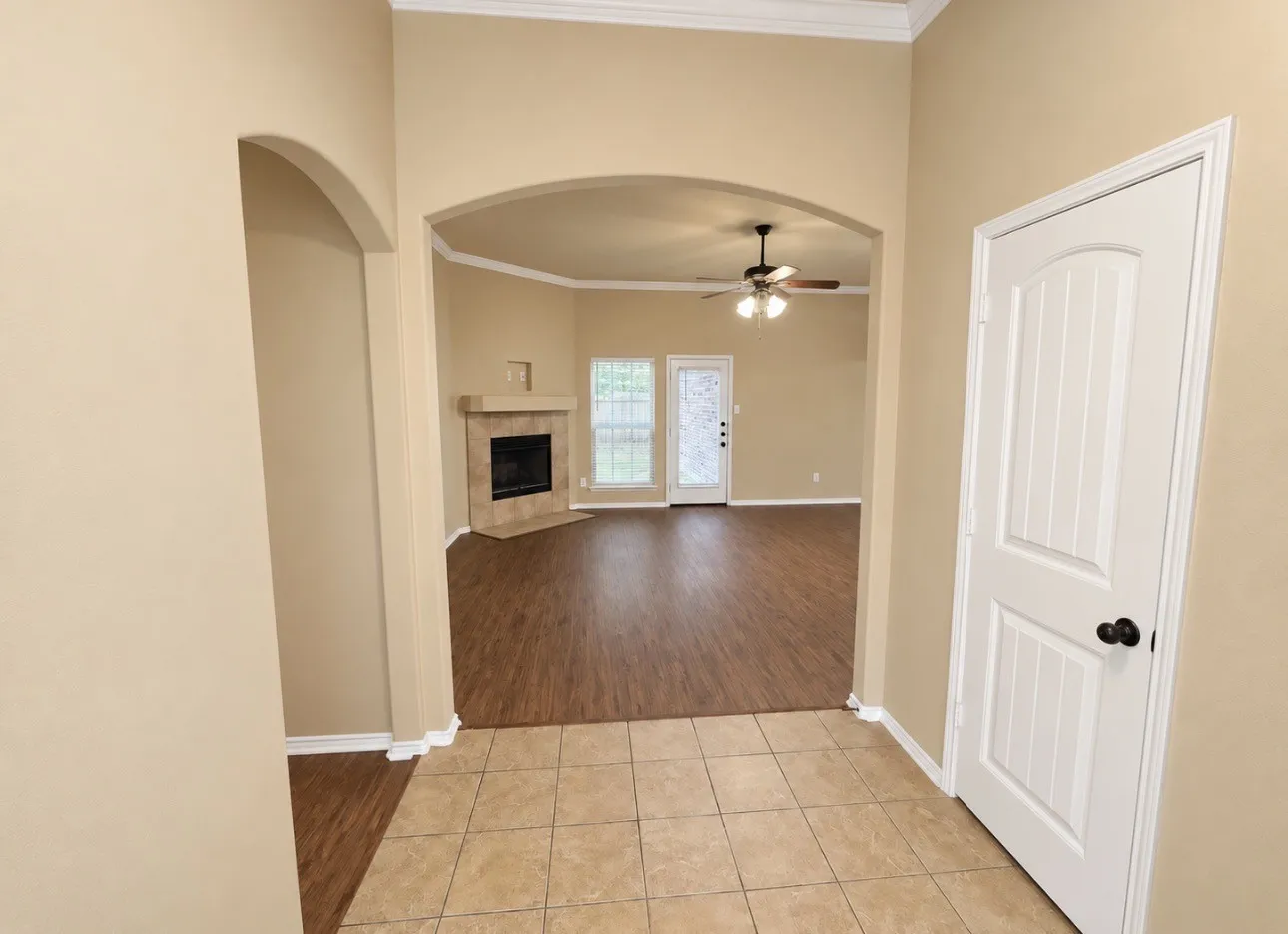 Arched entryway featuring tile flooring