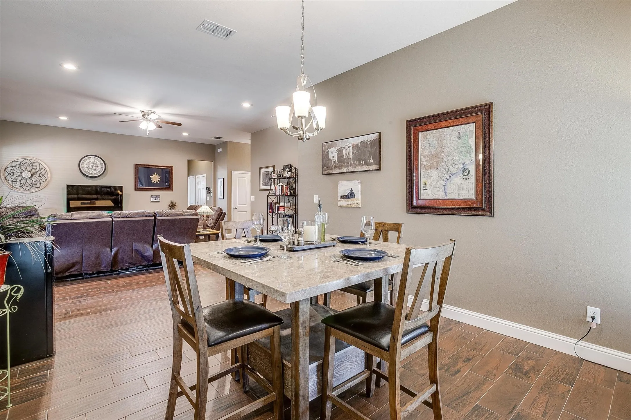 Open-concept living area featuring wood-finish flooring, recessed lighting, and a neutral wall palette