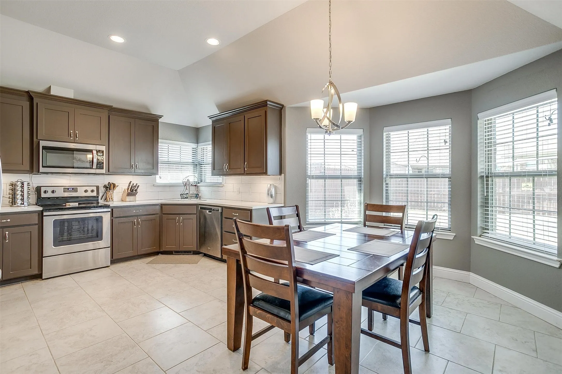 Kitchen featuring stainless steel appliances, white subway tile backsplash, white countertops, and recessed lighting