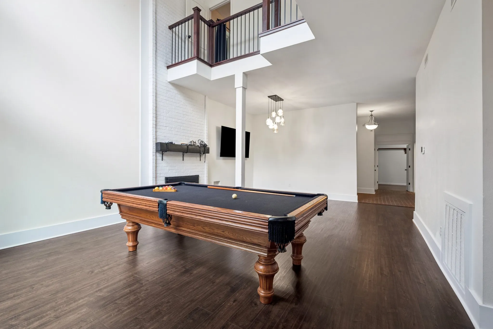 Tall ceilings featuring dark wood-finish flooring