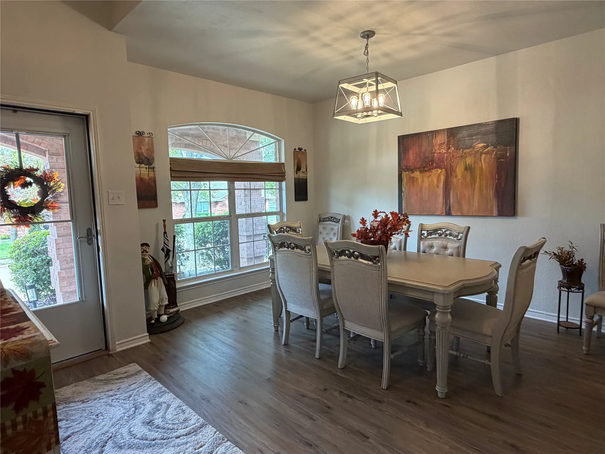 As You Enter, You Are Immediately Greeted by an Impressive Dining Room Featuring Floor-To-Ceiling Windows that Flood the Space with Natural Light