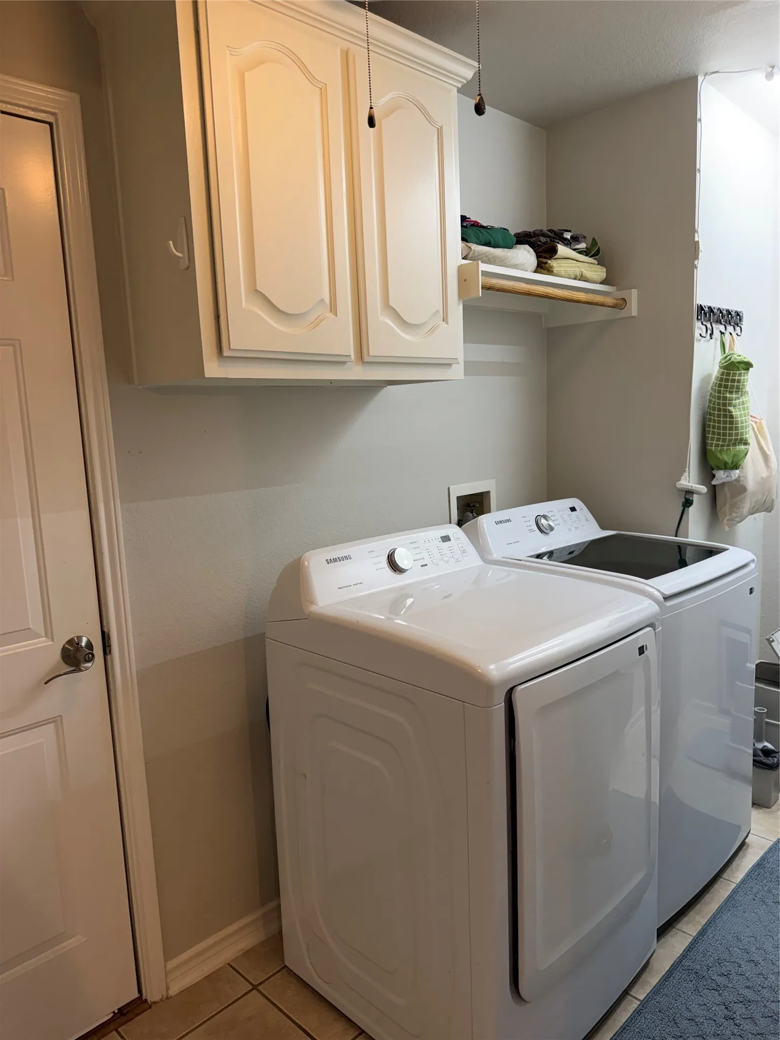 Nearby, the Functional Laundry Room is Complete with its Own Window and a Built-In Pet Door for Your Furry Family Members. Door to the Left is the Garage.