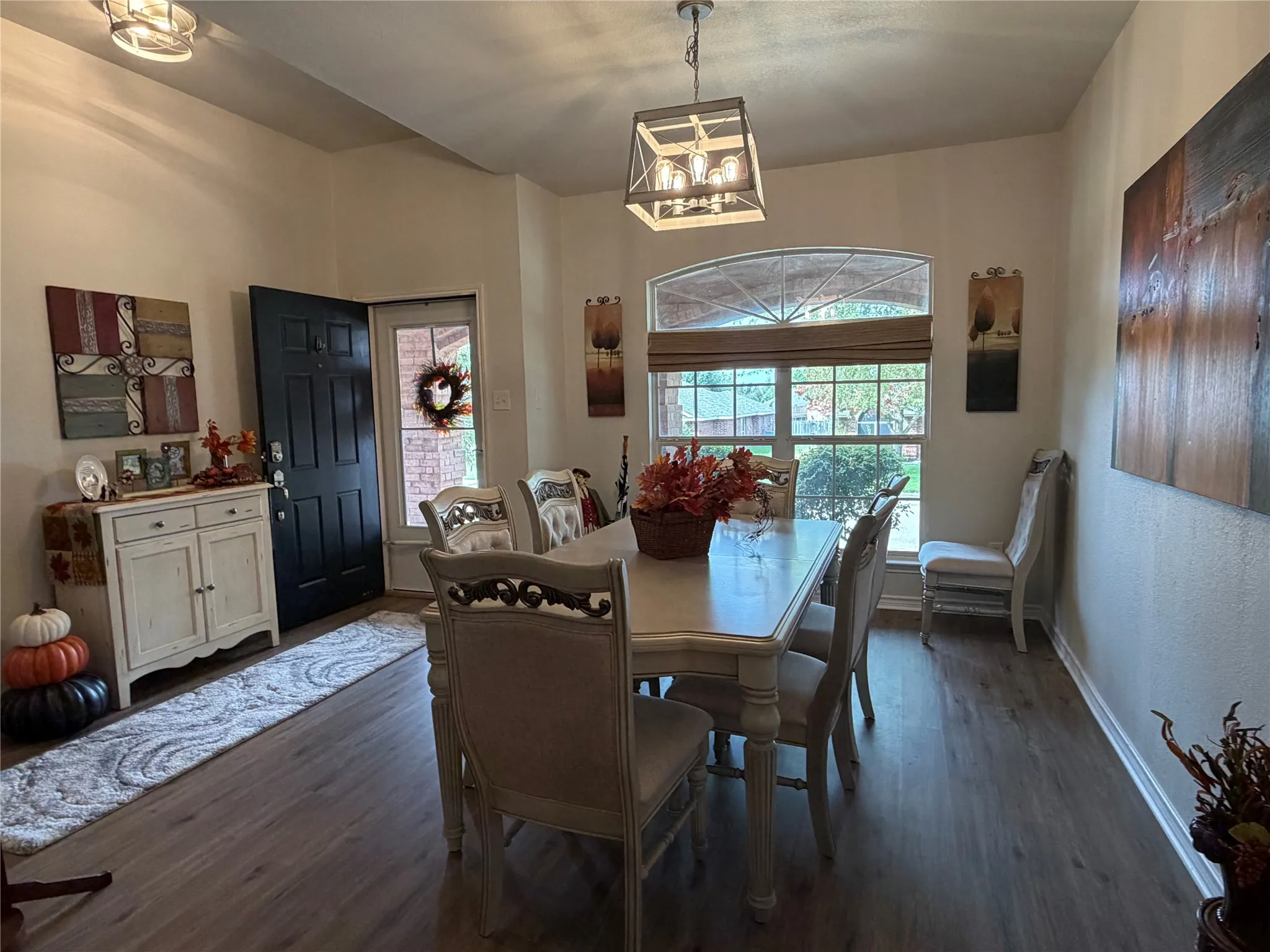 As You Enter, You Are Immediately Greeted by an Impressive Dining Room Featuring Floor-To-Ceiling Windows that Flood the Space with Natural Light