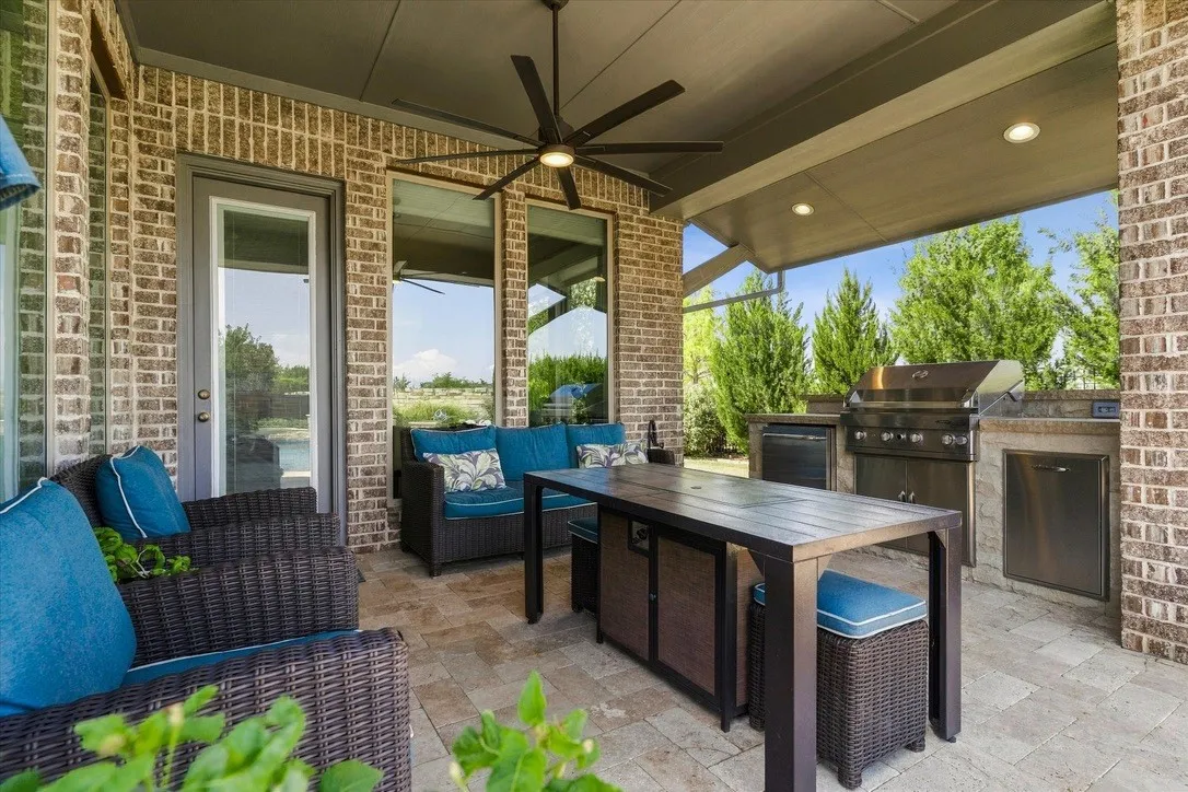 Outdoor kitchen with built in grill, refrigerator, and pull out trash can