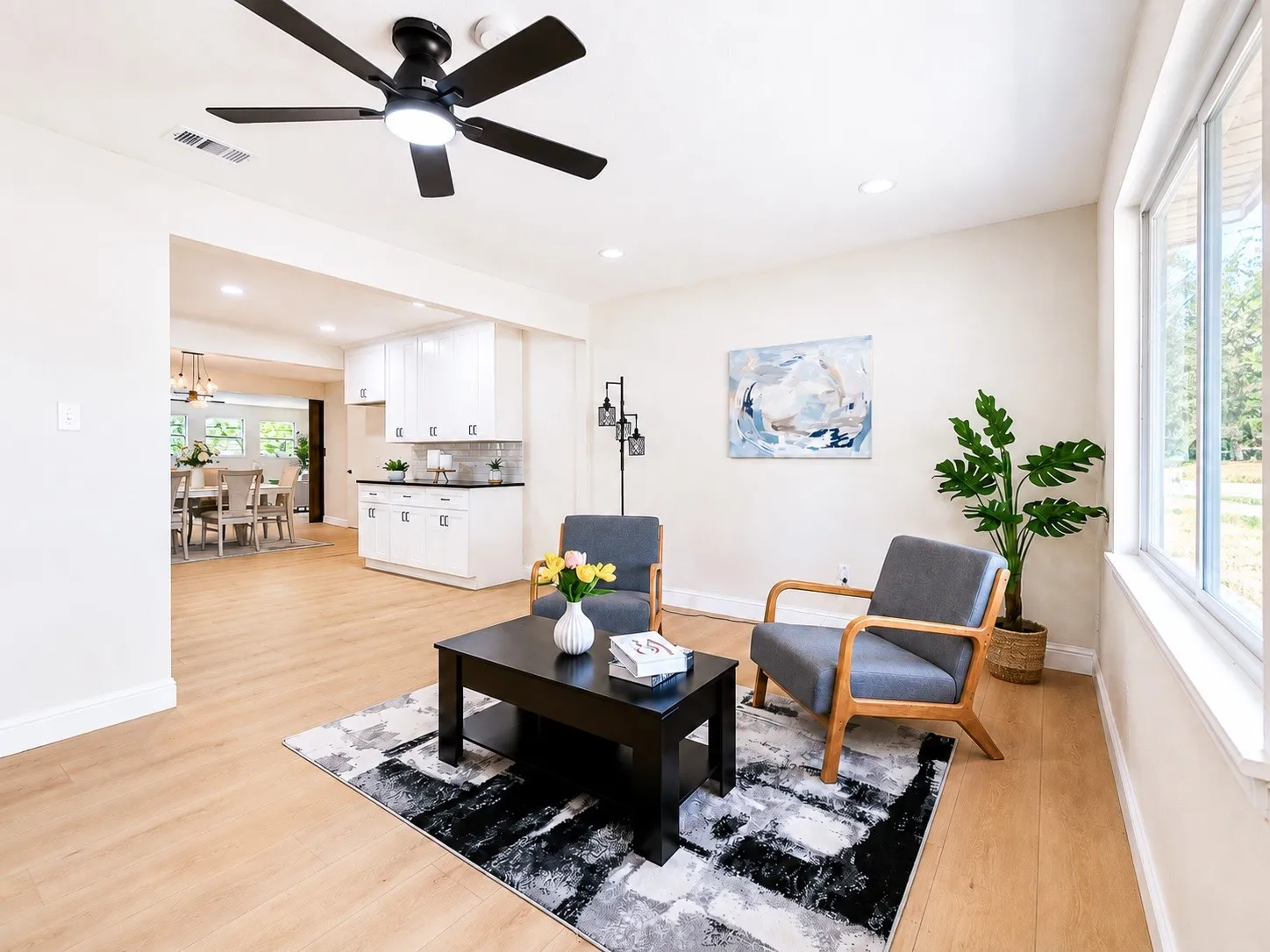 Wood-finish flooring throughout, recessed lighting, and a ceiling fan with integrated lighting