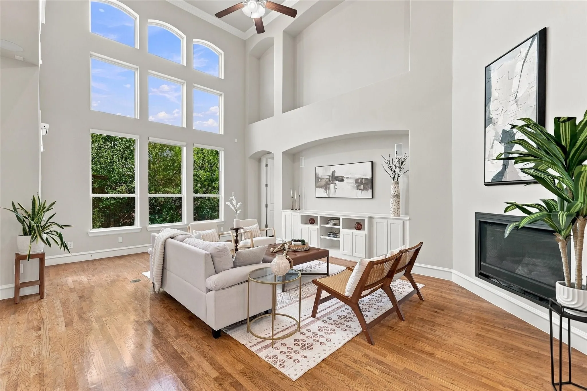 Living Room with vaulted ceilings and wall of windows providing ample natural light. LED ceiling lights installed, removes the need to change bulbs