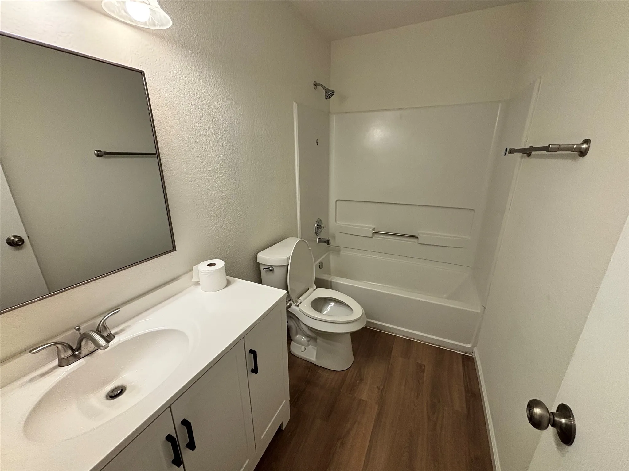 Vanity with integrated sink and brushed nickel faucet