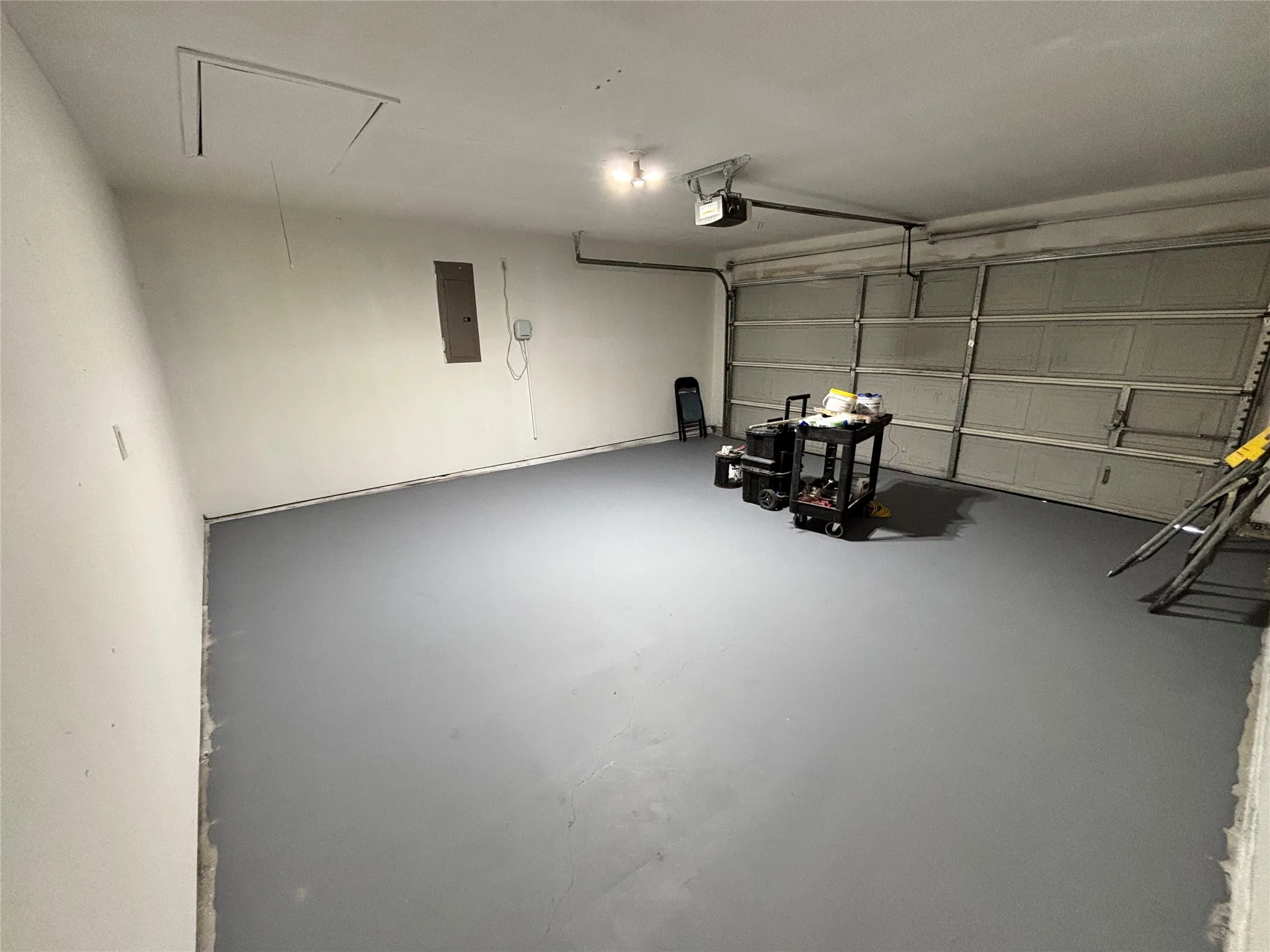 Spacious garage with a finished floor and overhead garage door