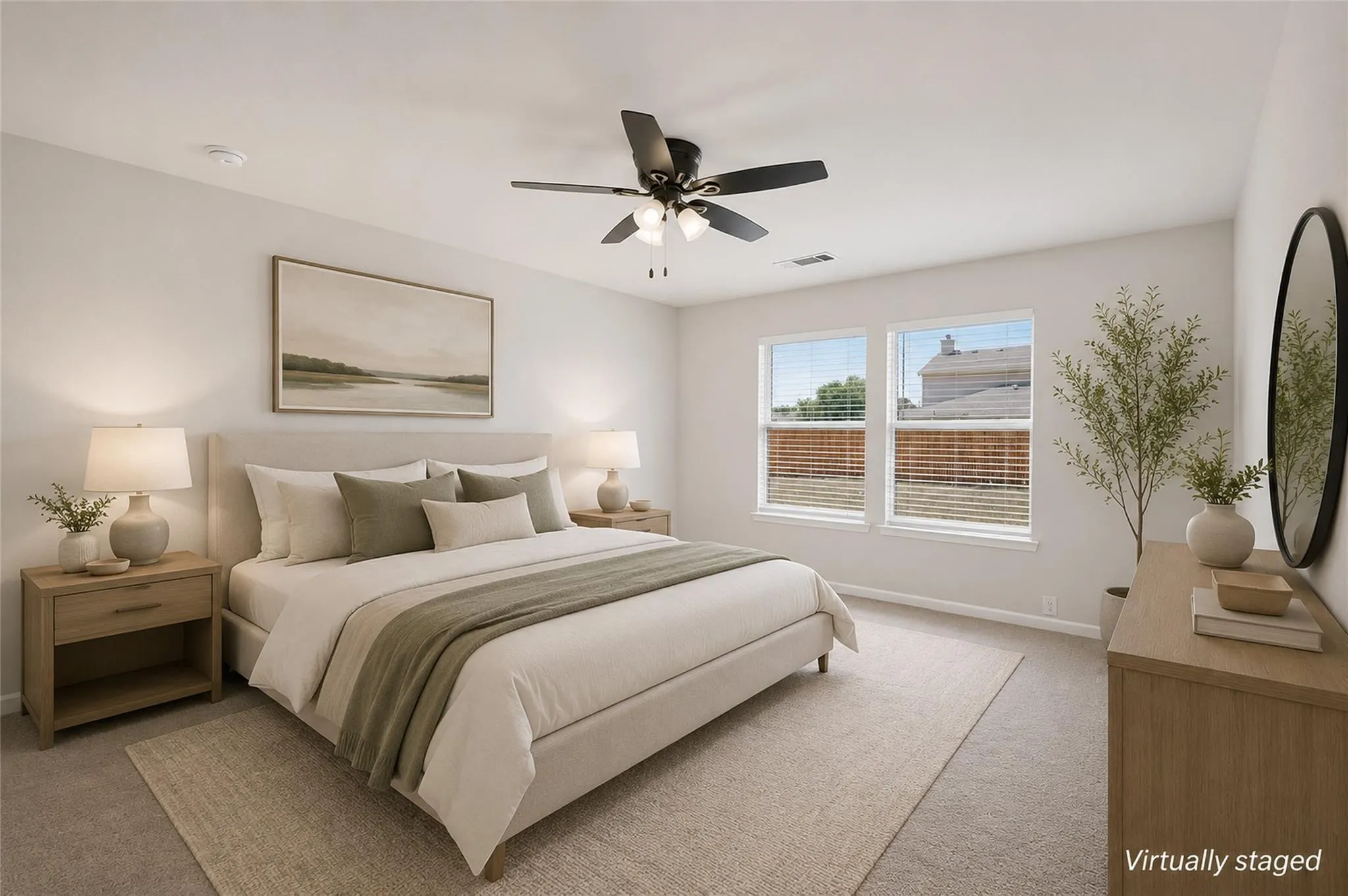 Spacious room with dual windows, overhead ceiling fan with lighting, and light-toned carpeting