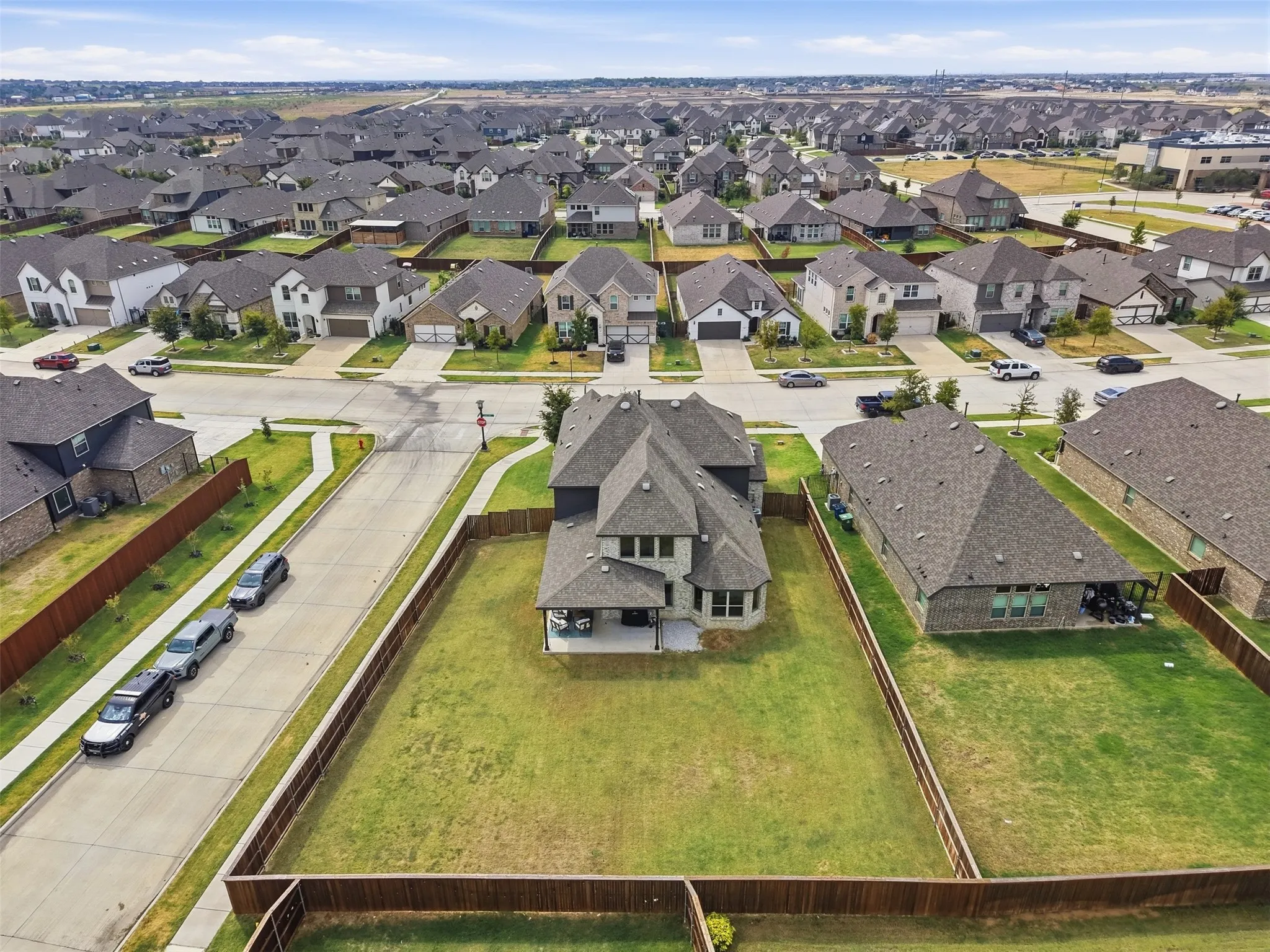 Expansive fenced backyard with a patio