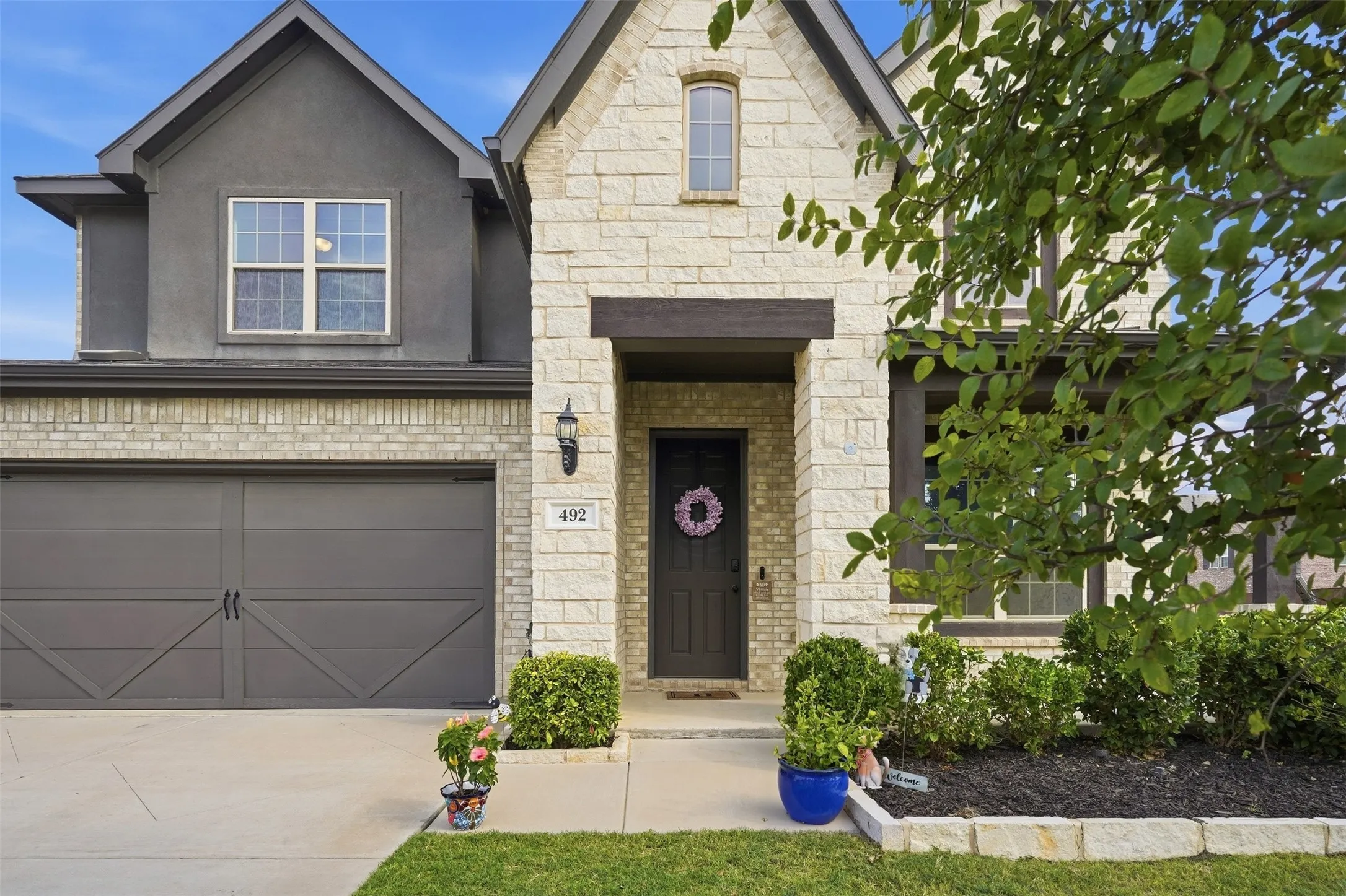 Stone and stucco exterior with brick accents