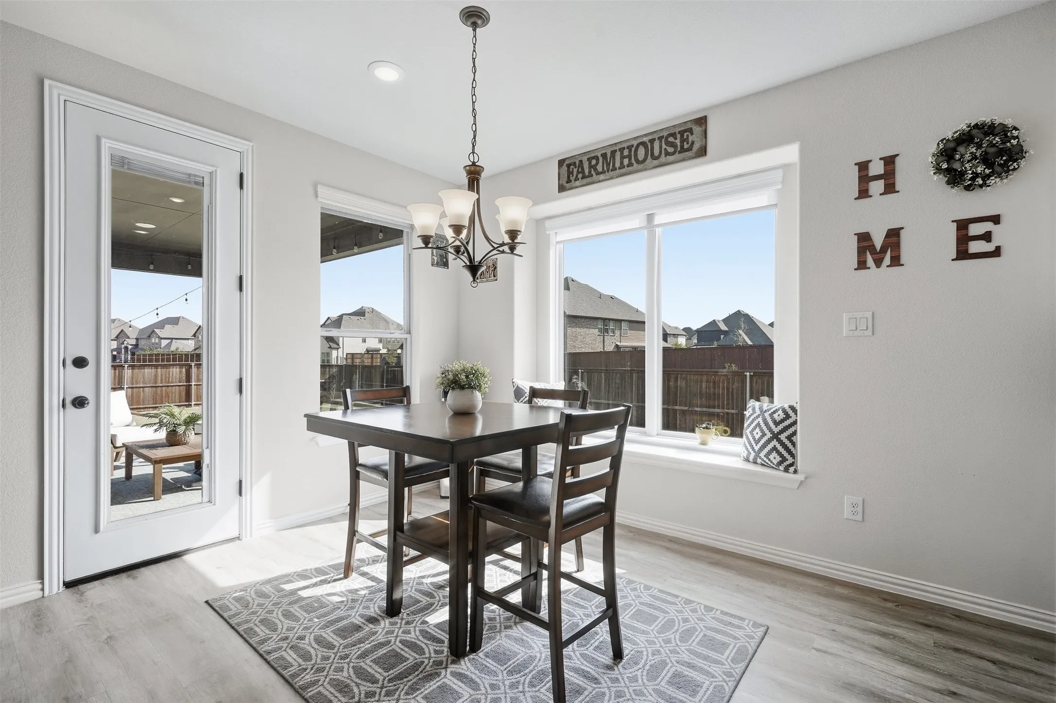 Recessed ceiling lighting, wood-finish flooring, white trim, and a glass-paneled exterior door