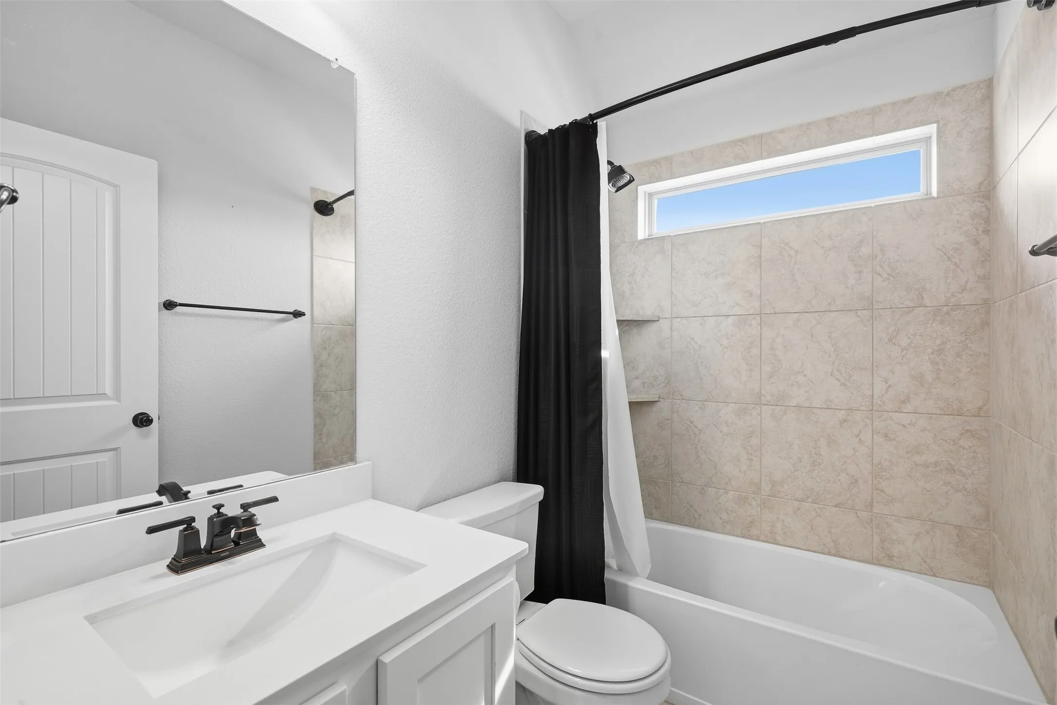 White vanity with integrated rectangular sink and oil-rubbed bronze faucet