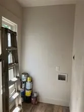 Laundry room with baseboards and wood finished floors