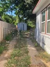 View of yard featuring a storage unit