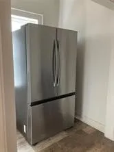Kitchen view of freestanding refrigerator