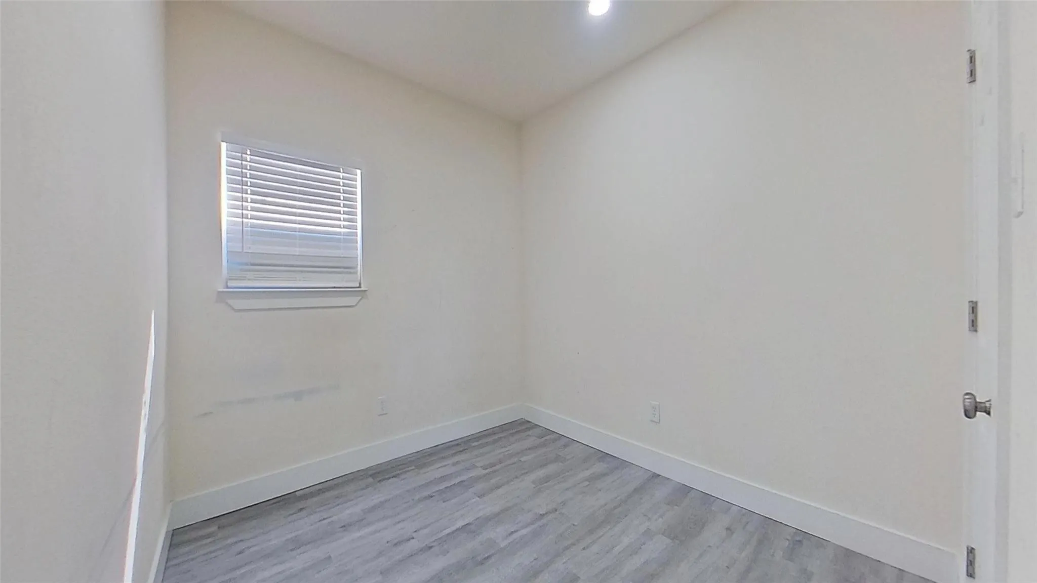 Recessed lighting, wood-finish flooring, window with blinds, solid core door