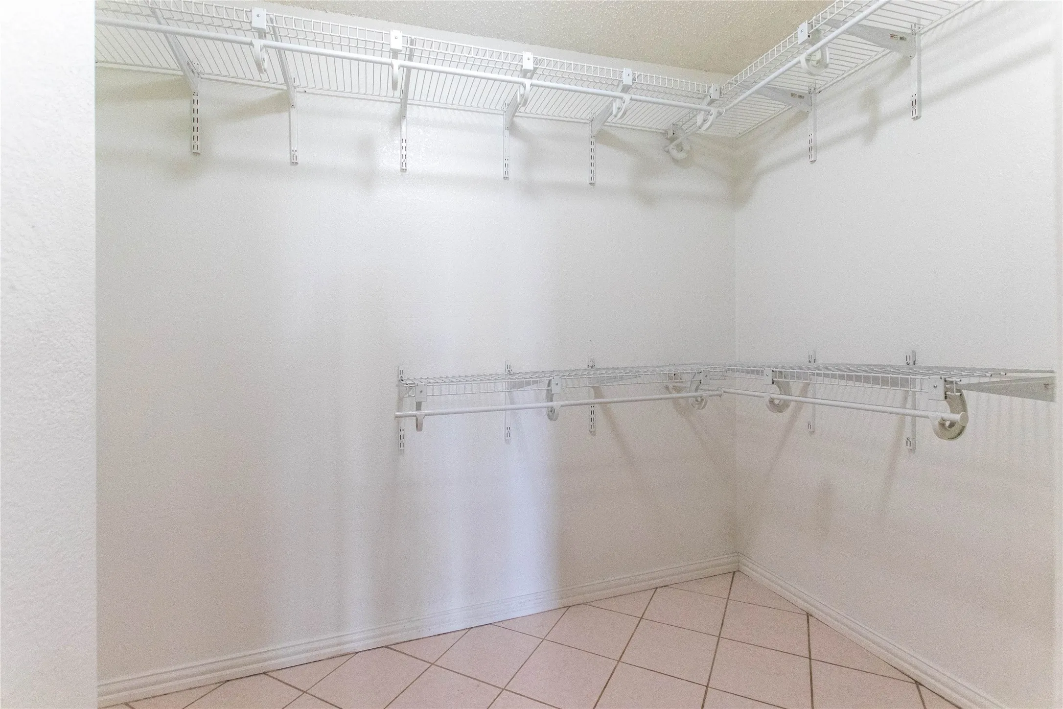 Built-in wire shelving system with hanging rods, offering abundant storage