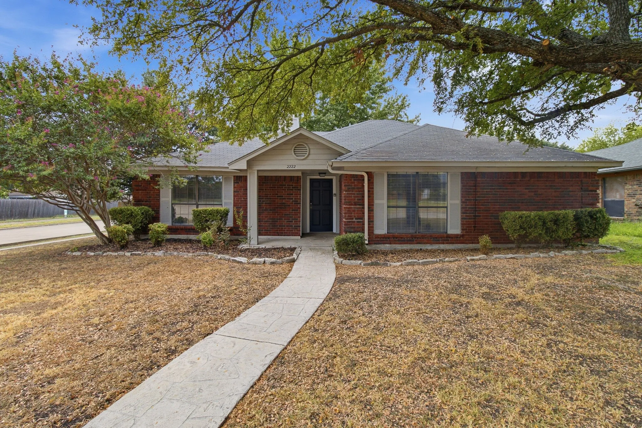 Brick exterior with white window shutters