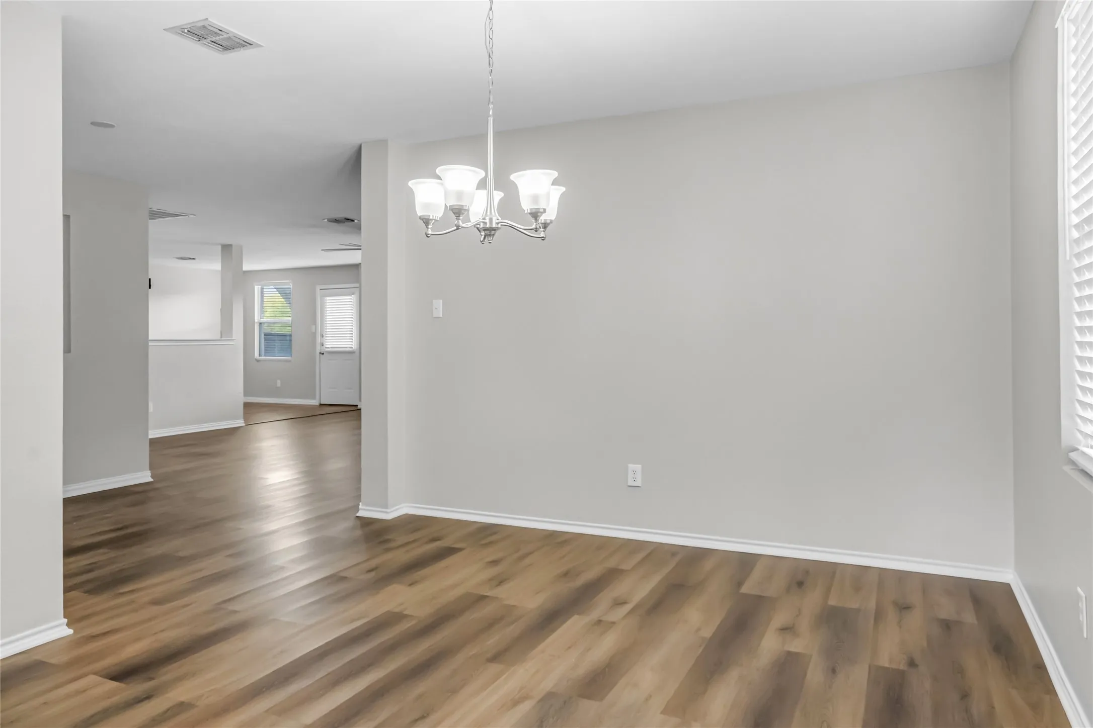 Wood-finish flooring throughout, complemented by light-toned walls