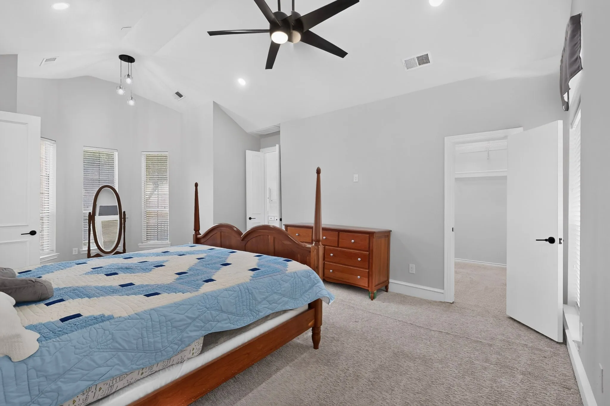 Vaulted ceiling with a contemporary ceiling fan, recessed lighting, and a modern pendant light fixture
