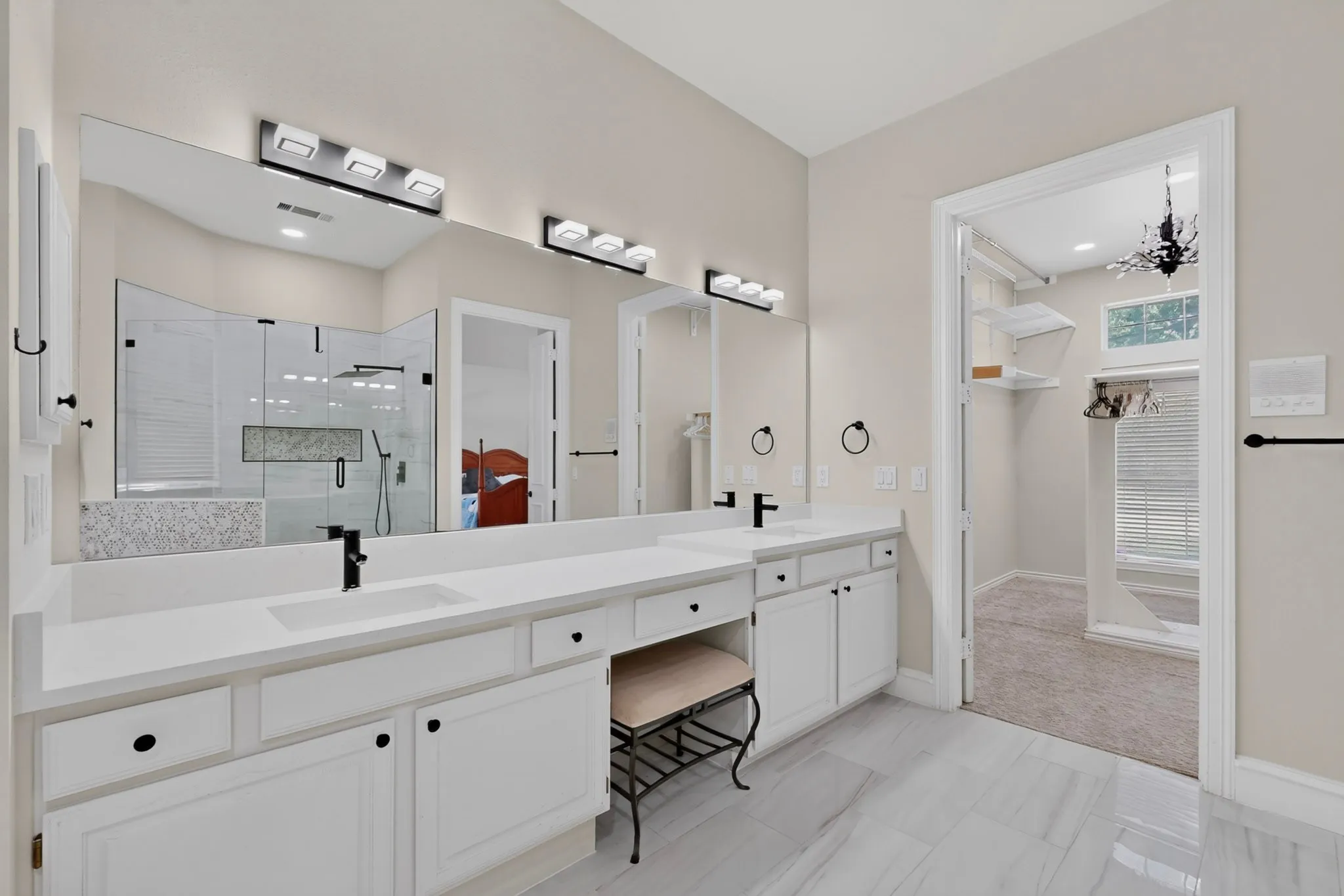 Dual vanity with white cabinetry, integrated sinks, and quartz countertops