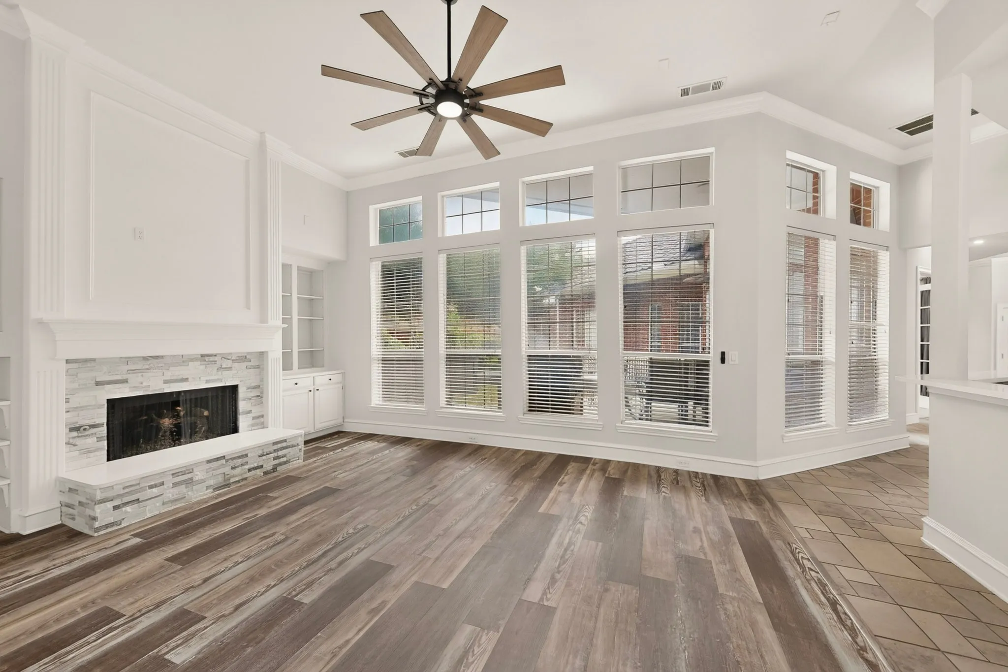 Wood-finish flooring, recessed lighting, and a ceiling fan
