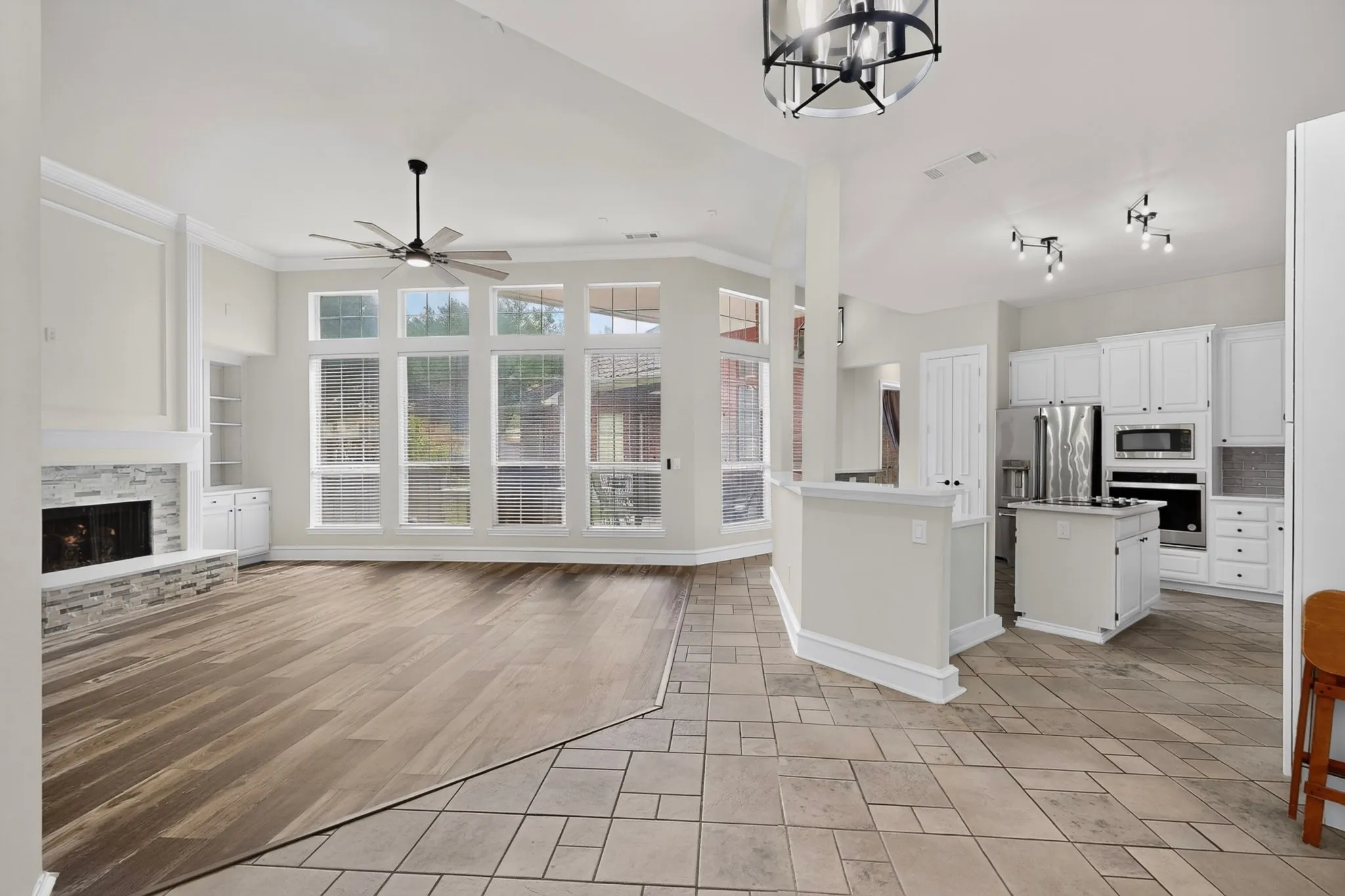 Bright, open-concept living space with abundant natural light from expansive multi-pane glass doors and windows