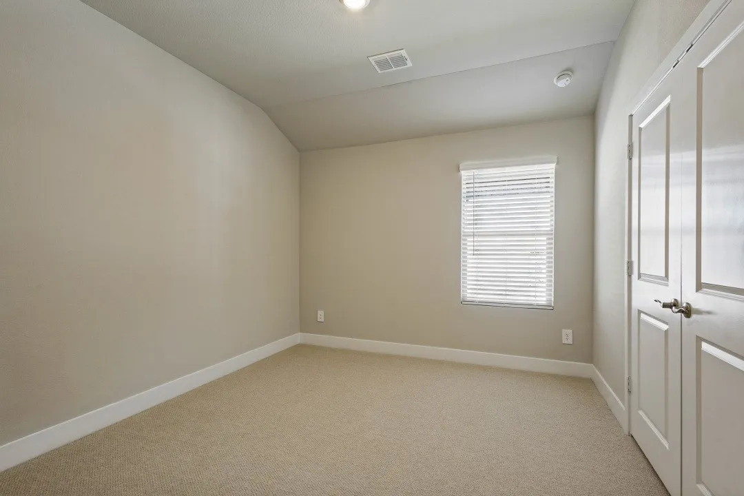 Neutral-toned carpeting with white baseboards