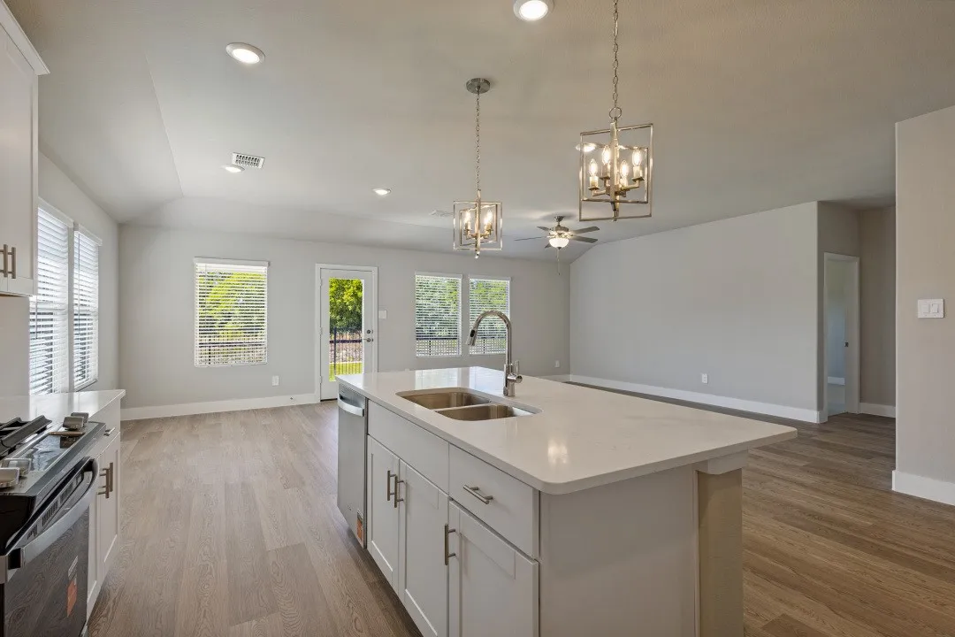Kitchen island with an undermount dual-basin sink and an integrated dishwasher