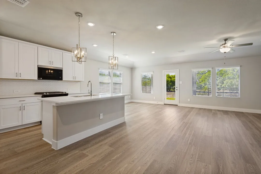 Open-concept living space with wood-finish flooring
