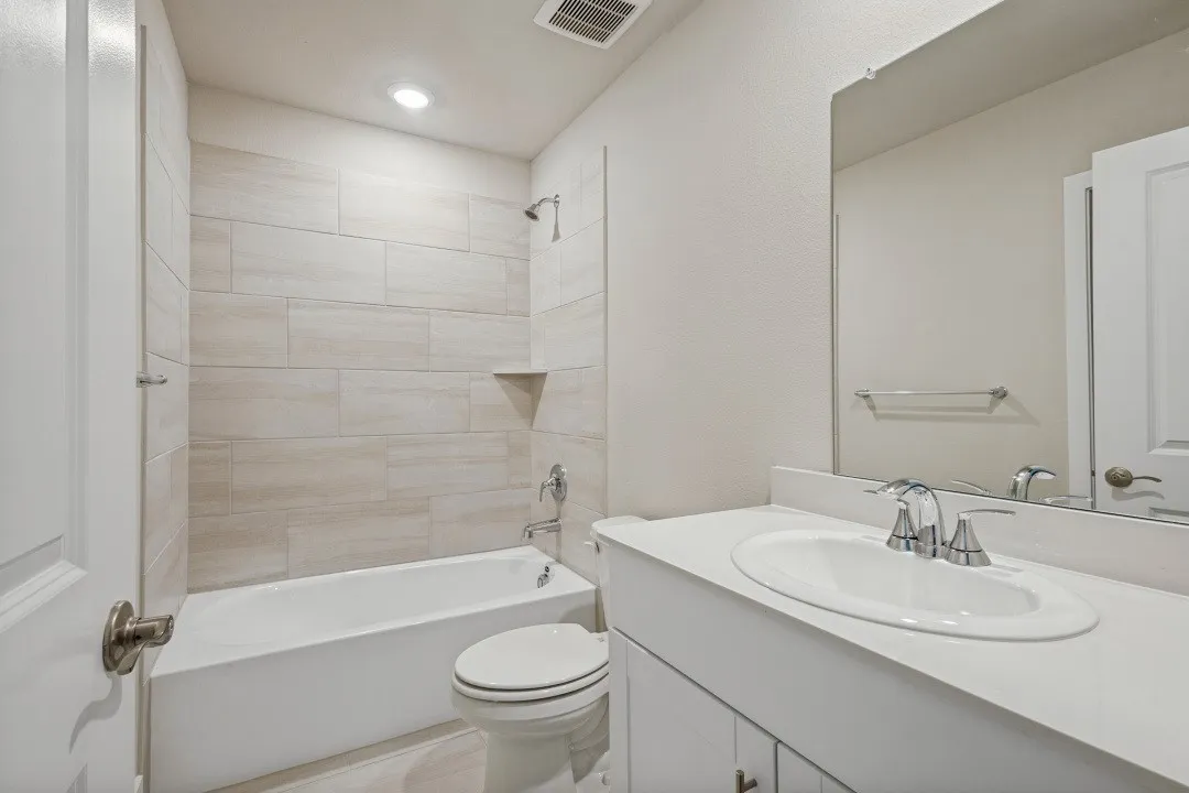 Vanity with white countertop, chrome faucet, and integrated sink