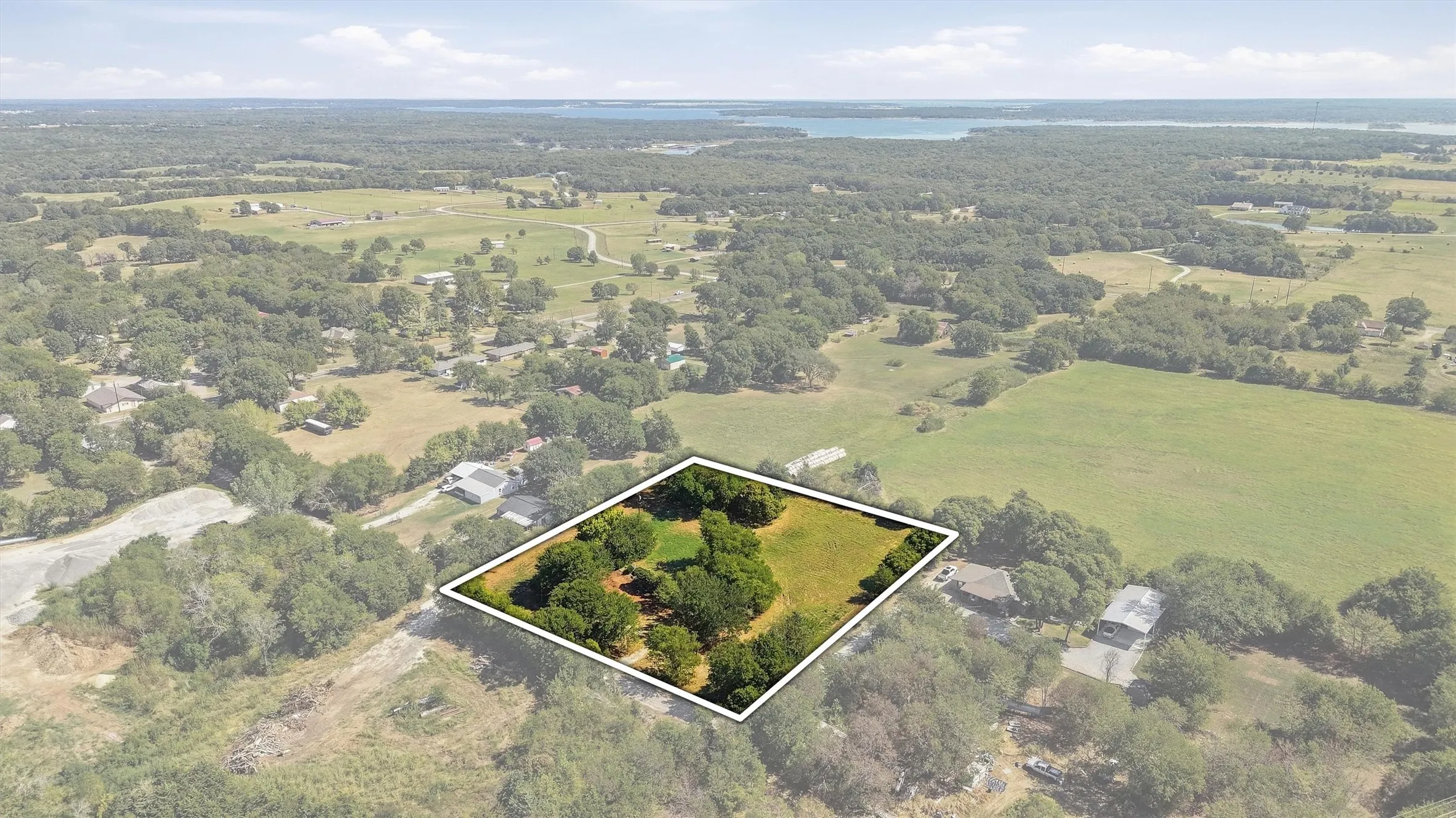 Expansive land parcel featuring open clearings and mature trees