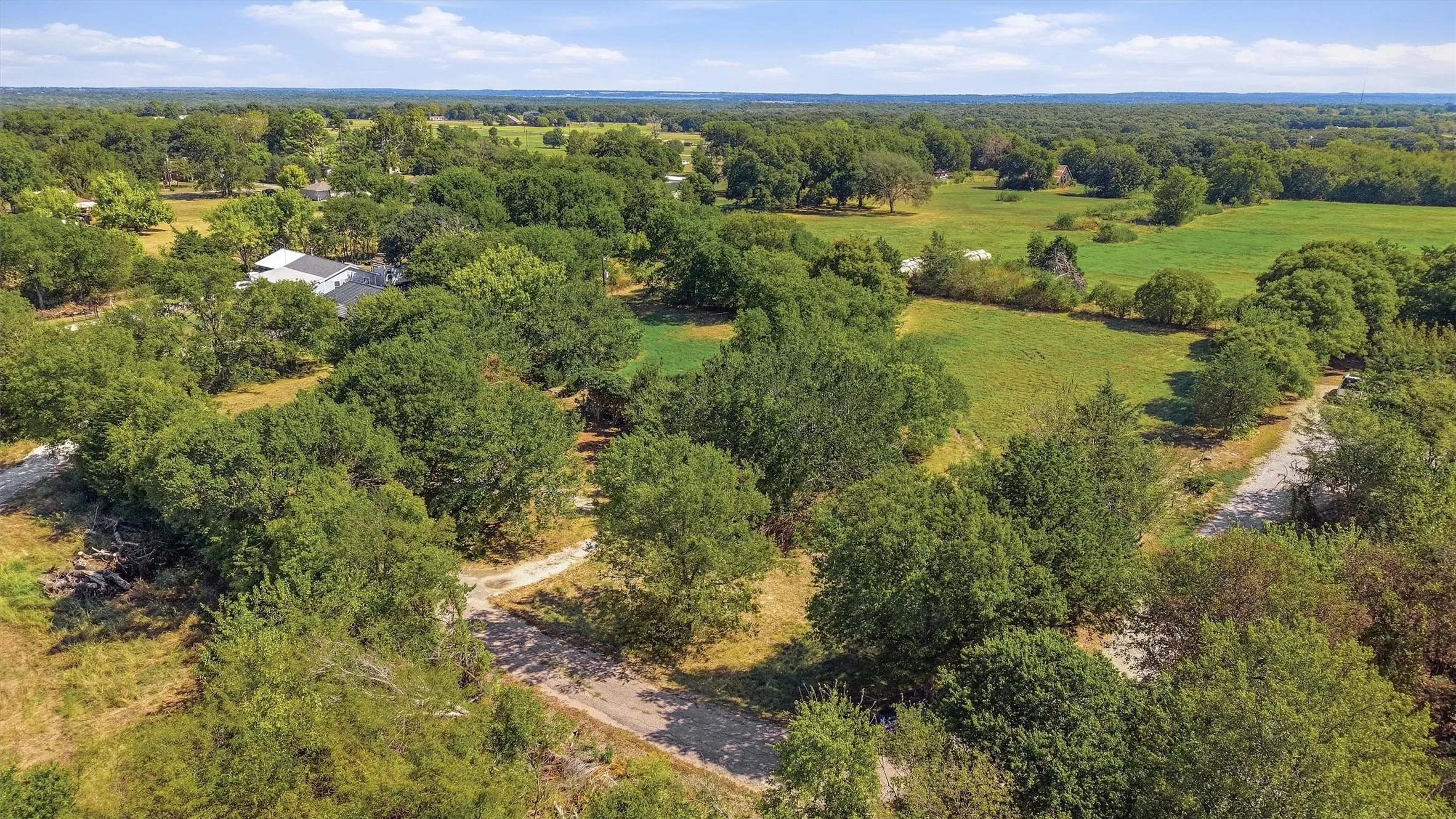 Expansive property featuring mature trees and open green spaces