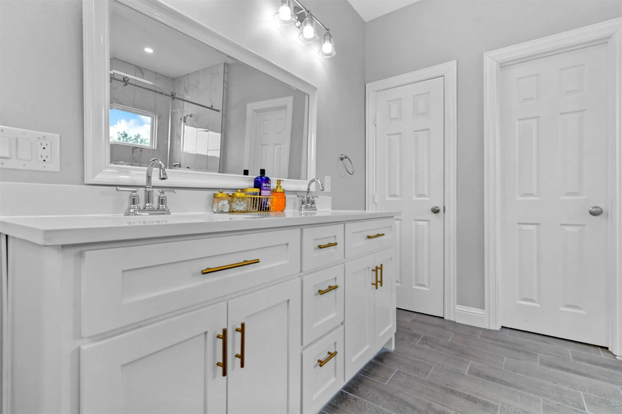 Double vanity with integrated sinks and gold-finish hardware