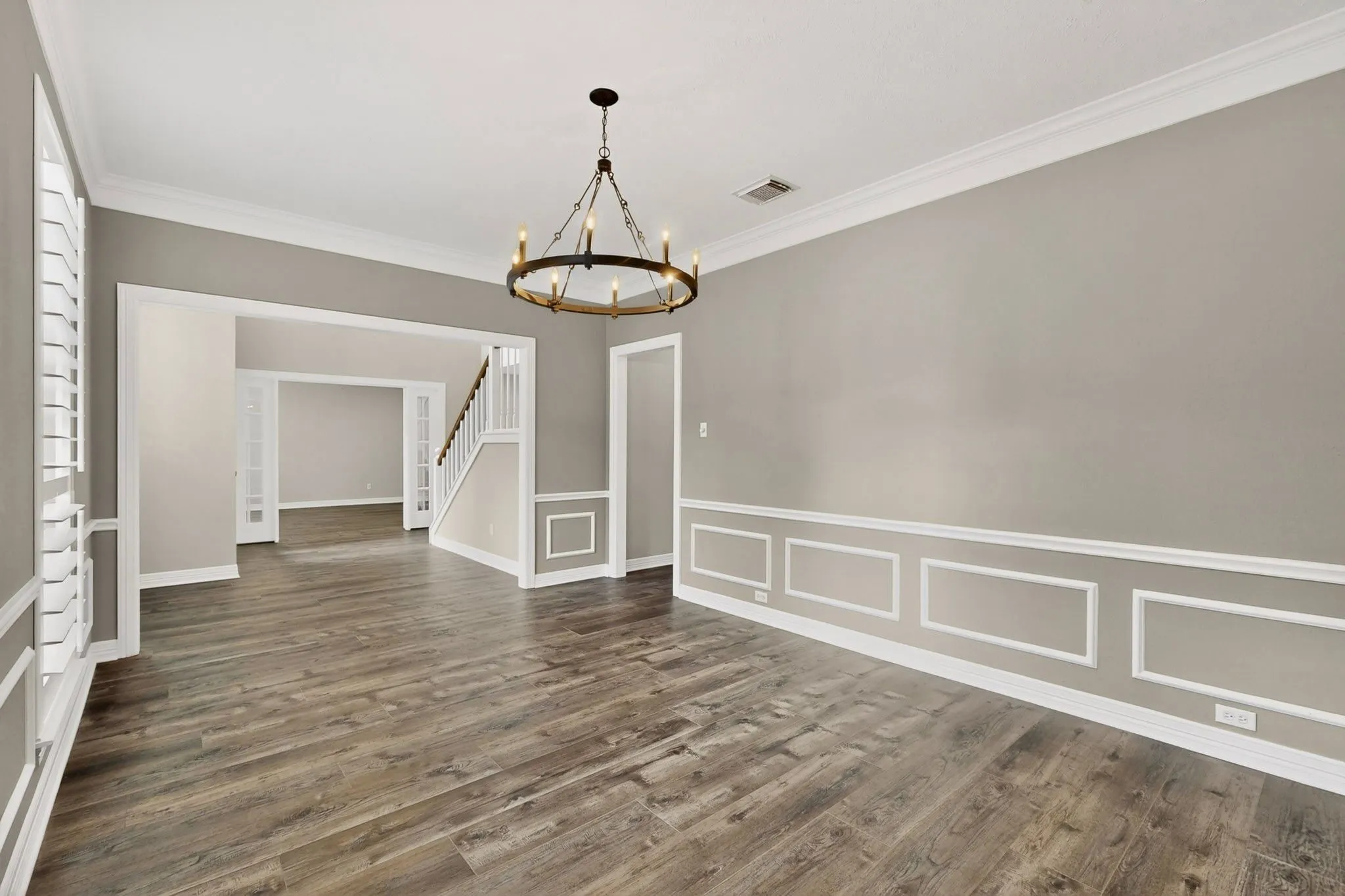 Wood-finish flooring throughout, complemented by crown molding and wainscoting