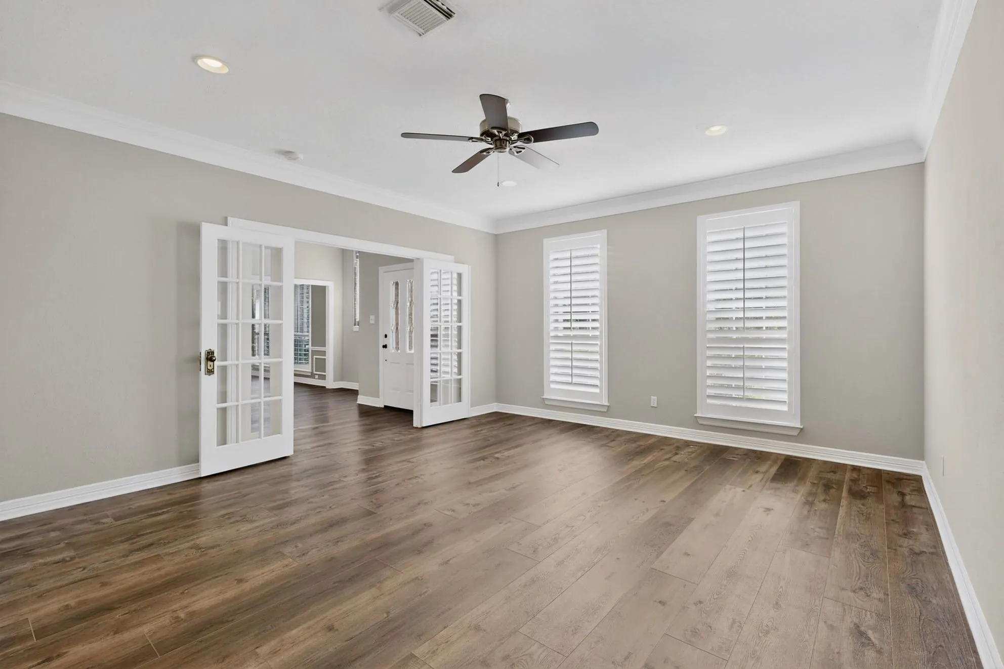 Wood-finish flooring throughout, recessed lighting, and crown molding