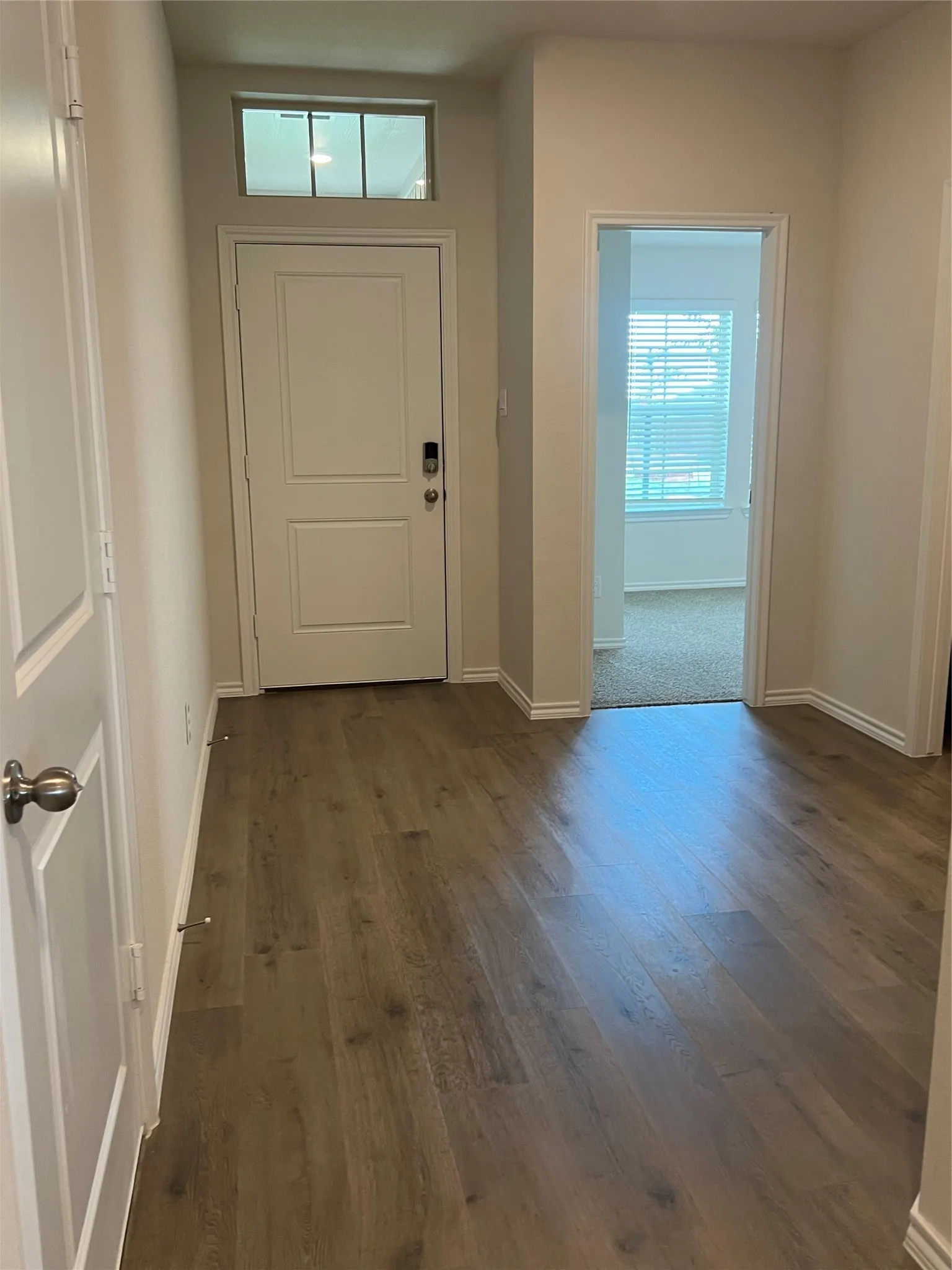 Entryway with baseboards and dark wood finished floors