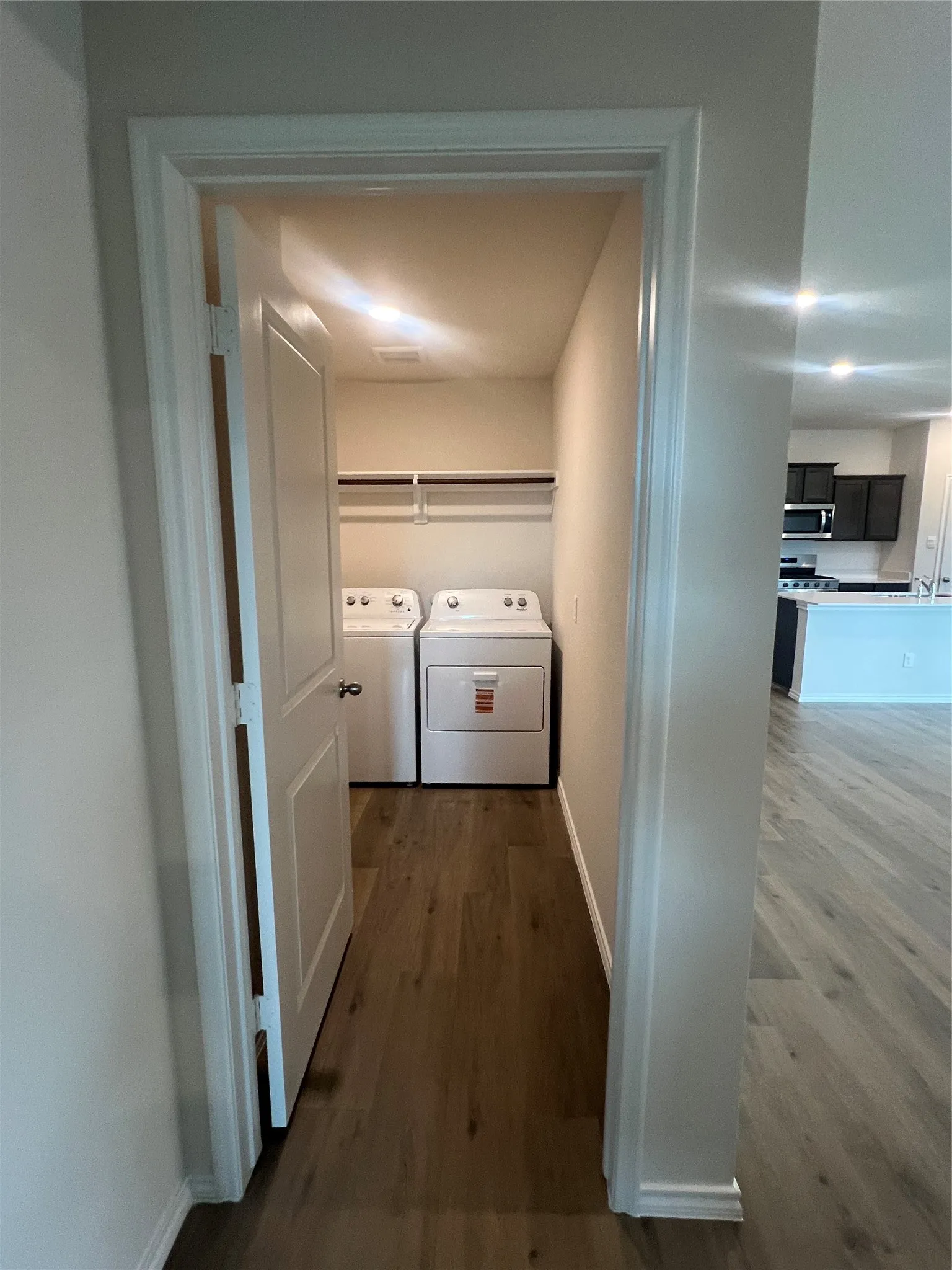 Laundry room with vinyl flooring with brand new washer and dryer