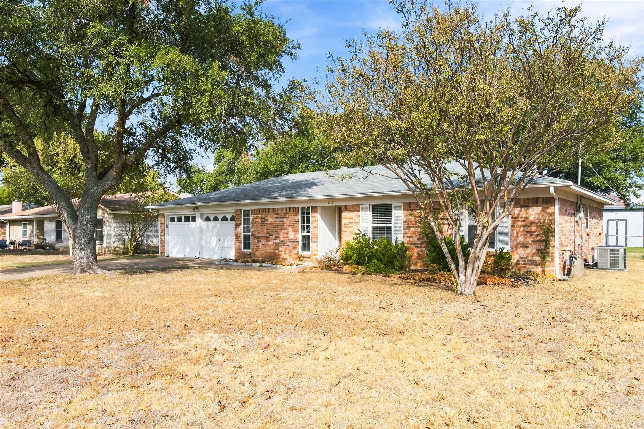 Brick exterior with white window shutters and trim